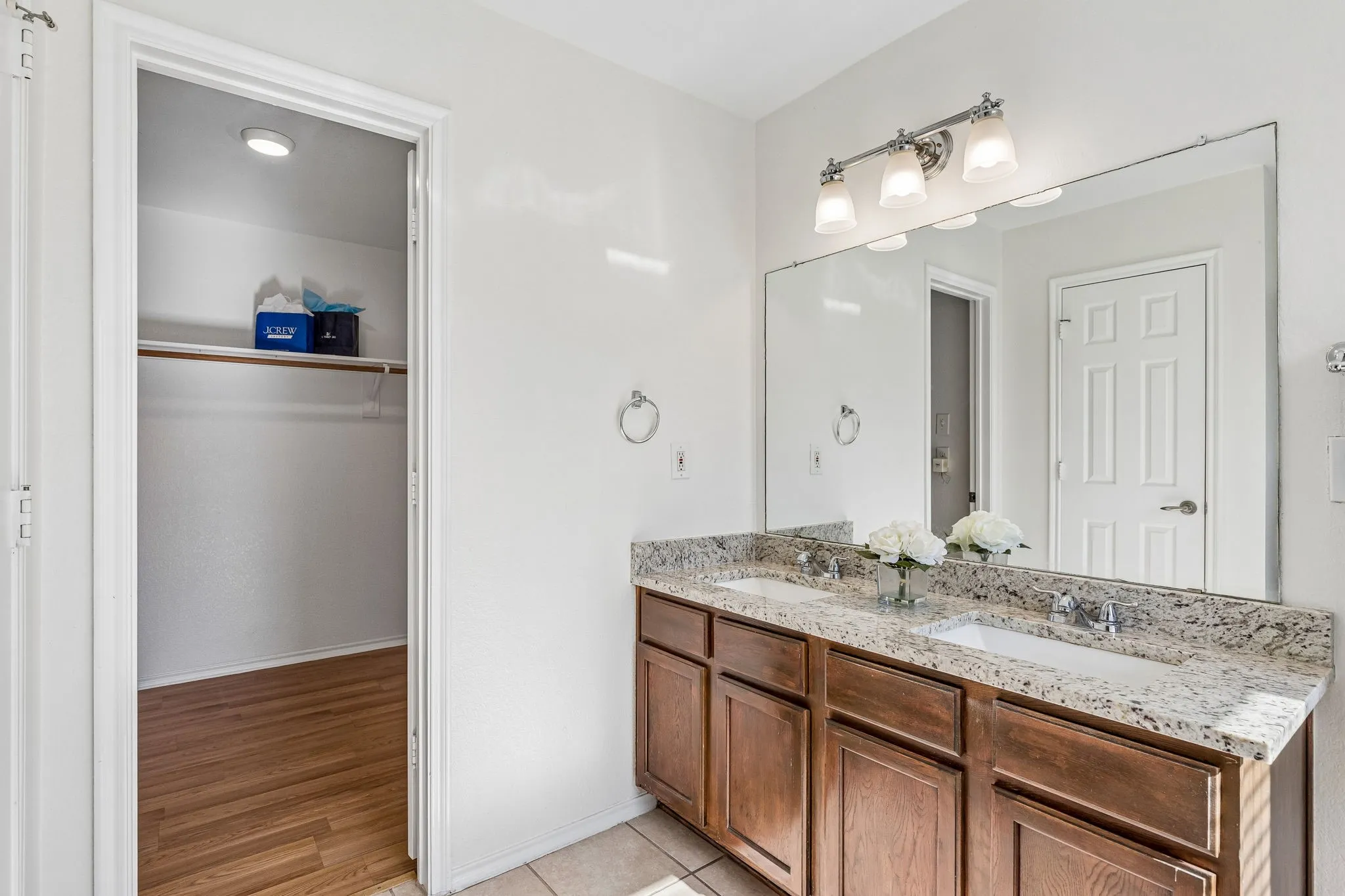 The primary bath features dual granite vanities, generous counter space and abundant storage.