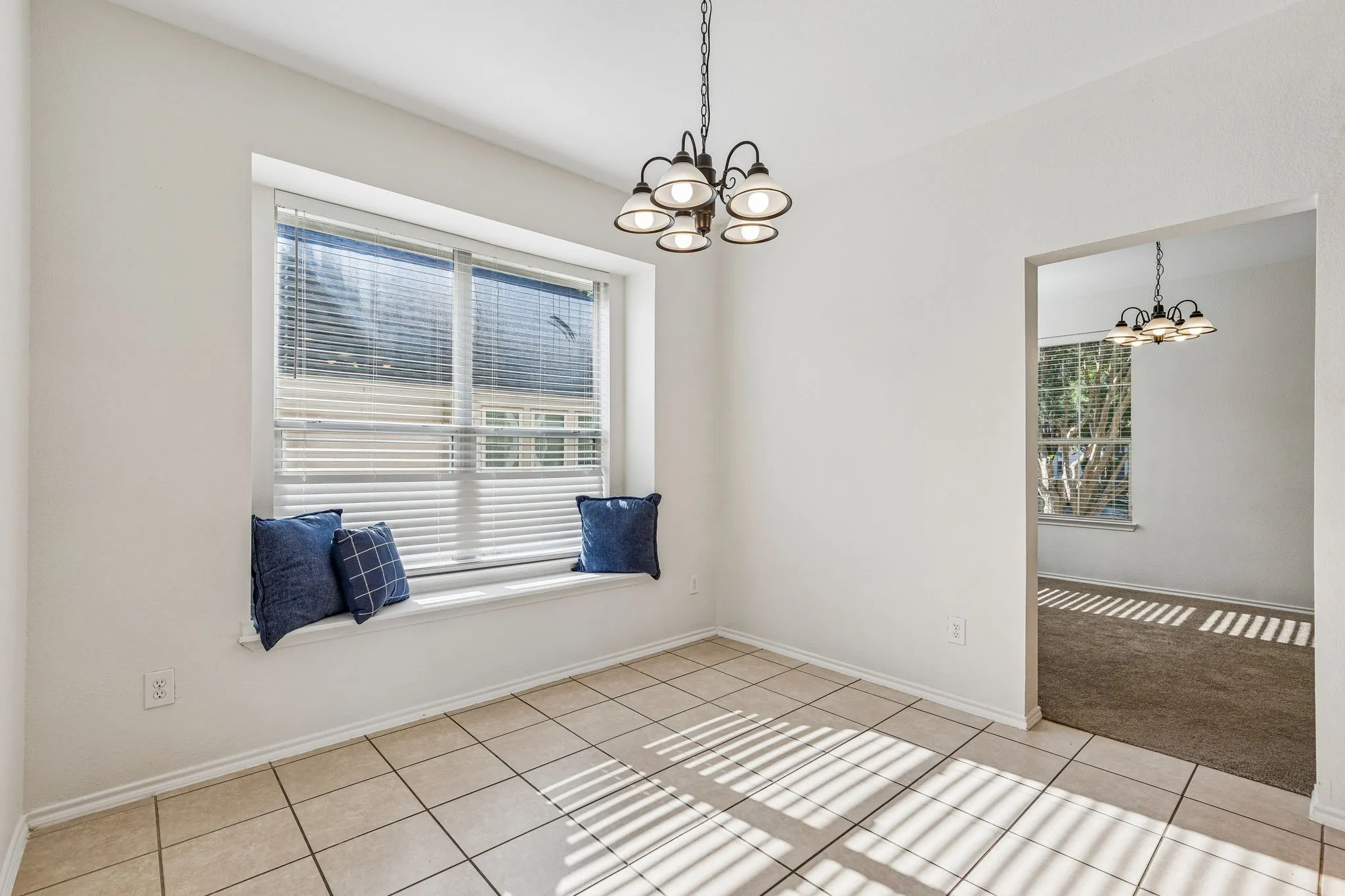Enjoy morning coffee in the charming breakfast nook featuring a cozy window seat overlooking the backyard.