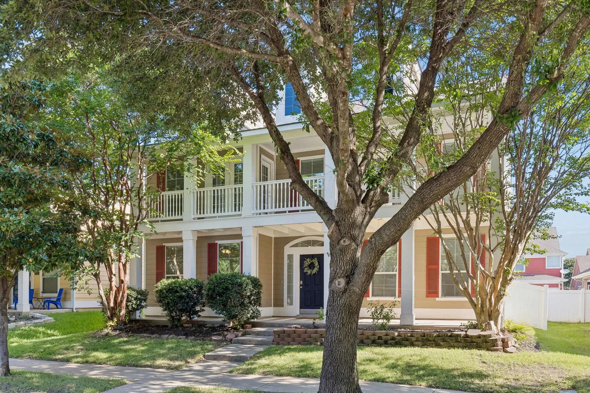 Situated on an interior homesite beneath mature shade trees, this Providence Village home offers welcoming curb appeal and classic architectural character.
