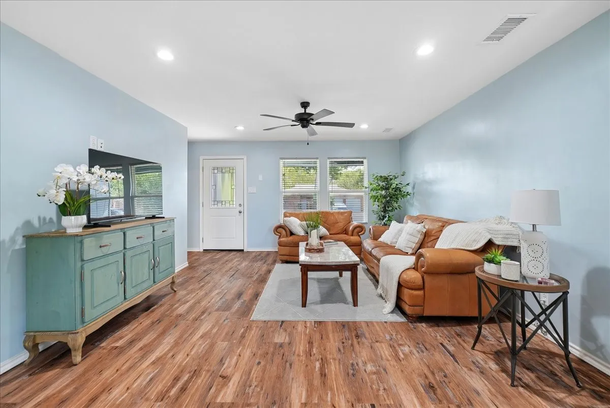 Wood-finish flooring, recessed lighting, and a ceiling fan