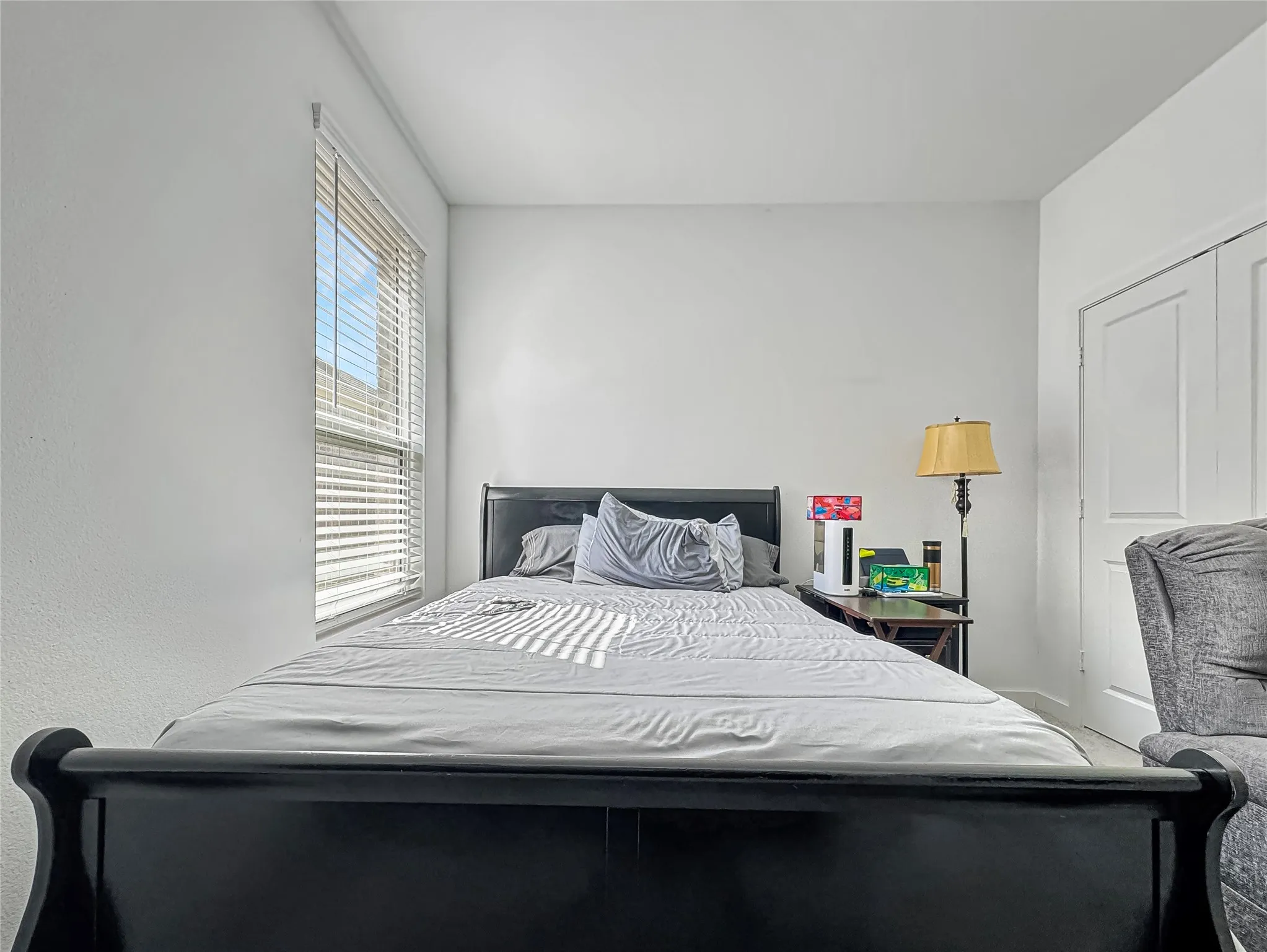 White painted walls, window with blinds, and white paneled doors