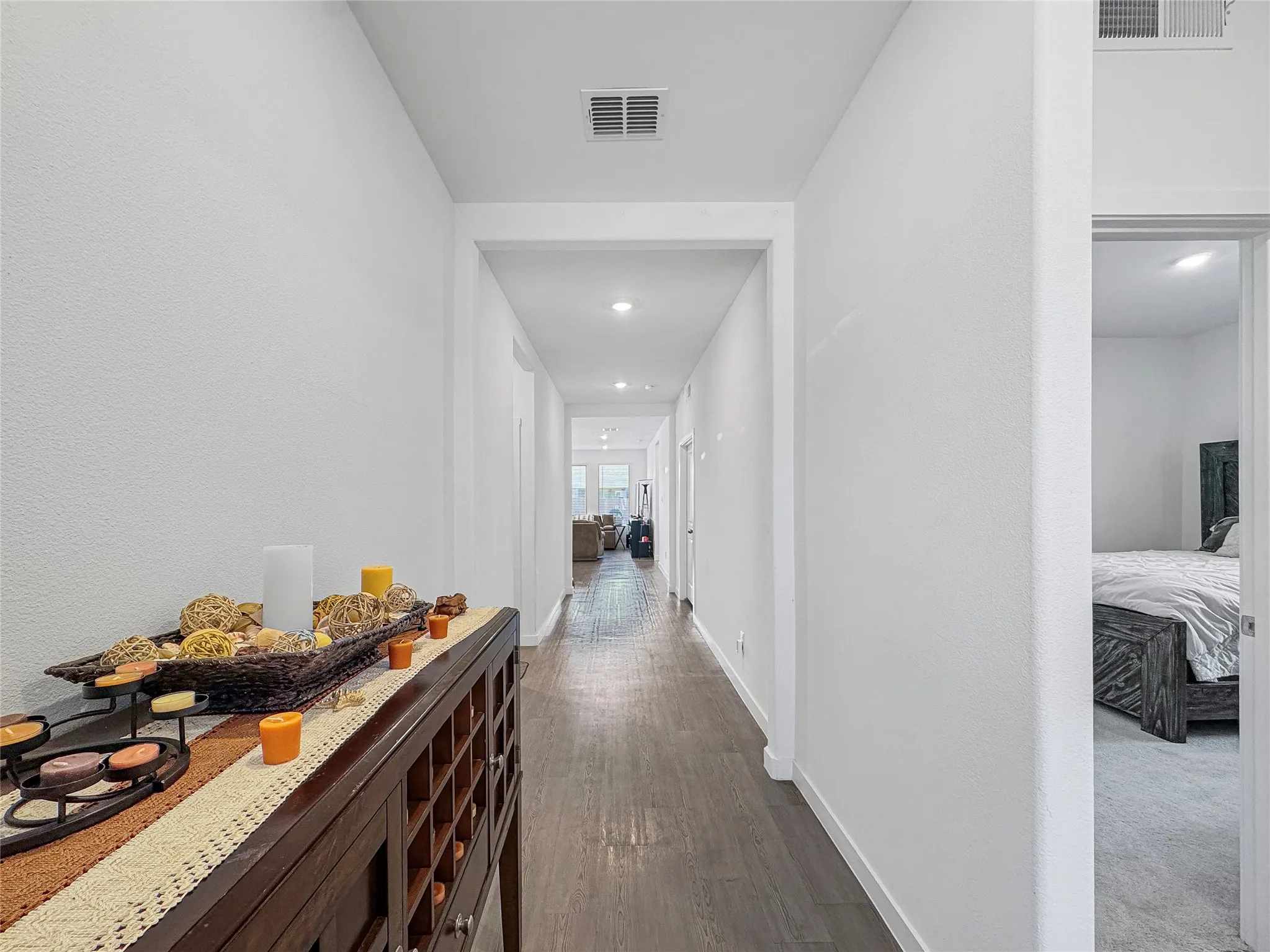 Hallway featuring wood-finish flooring, recessed lighting, and white walls