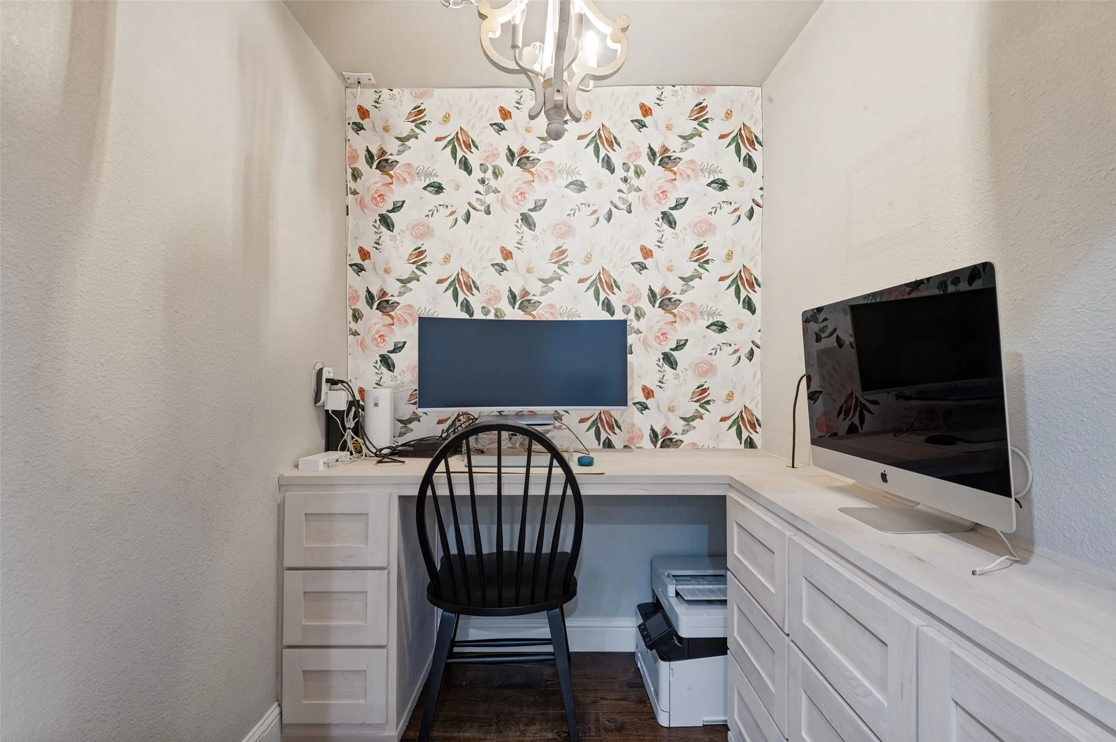 Built-in desk with integrated storage and drawers, wood flooring in office