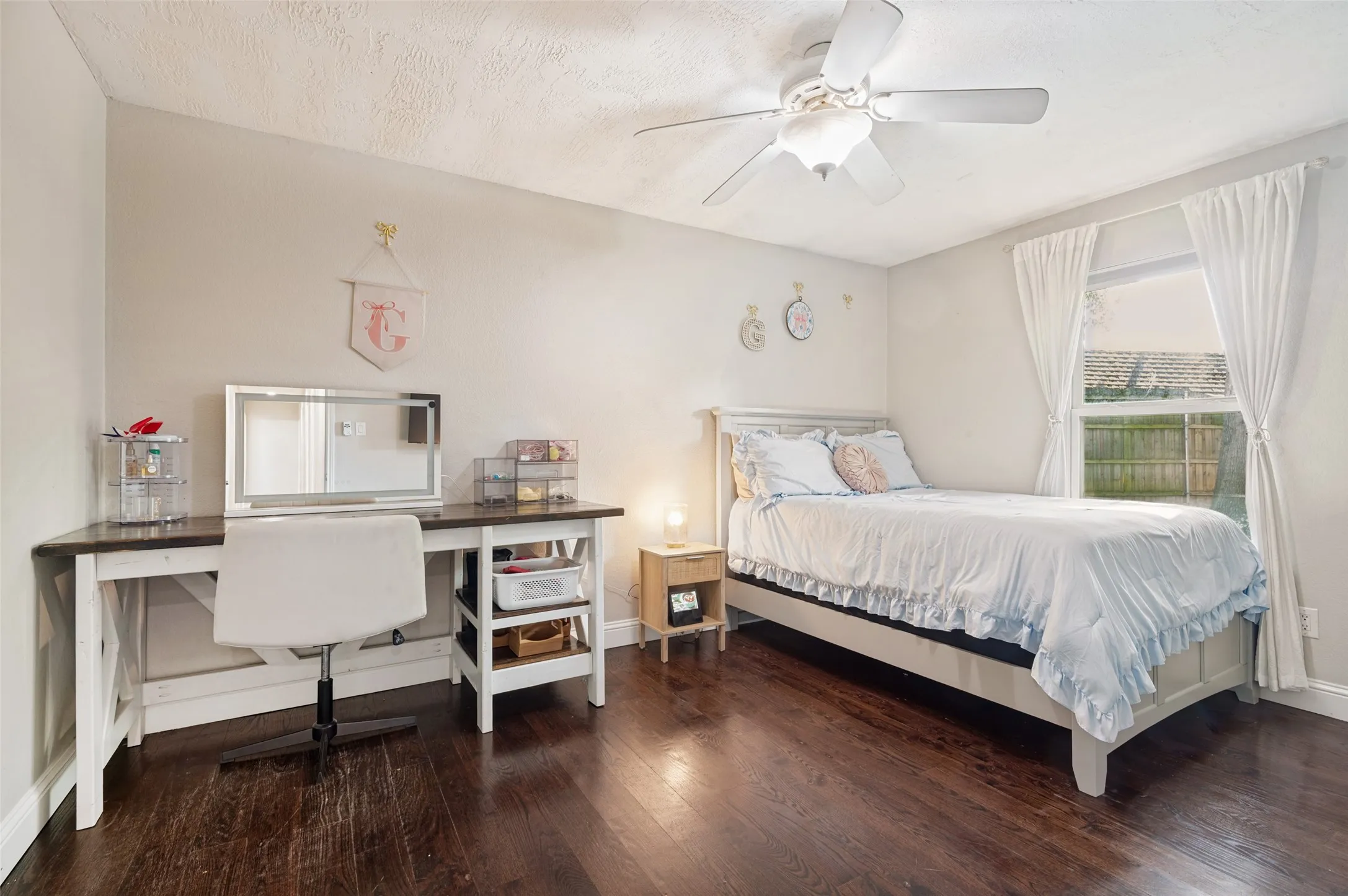 Wood flooring, ceiling fan in bedroom