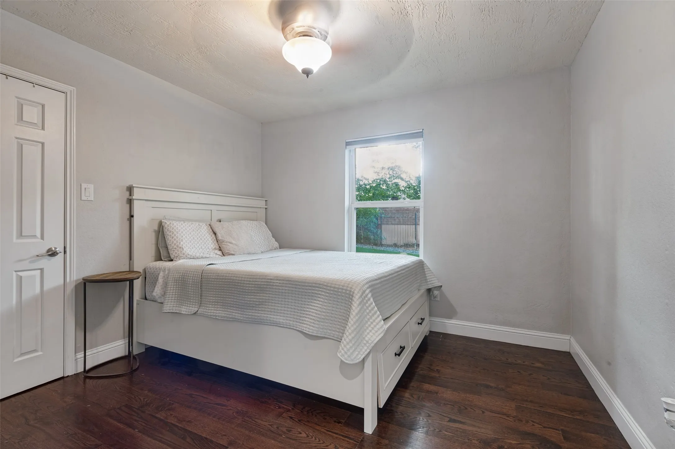 Wood flooring with ceiling fan in bedroom