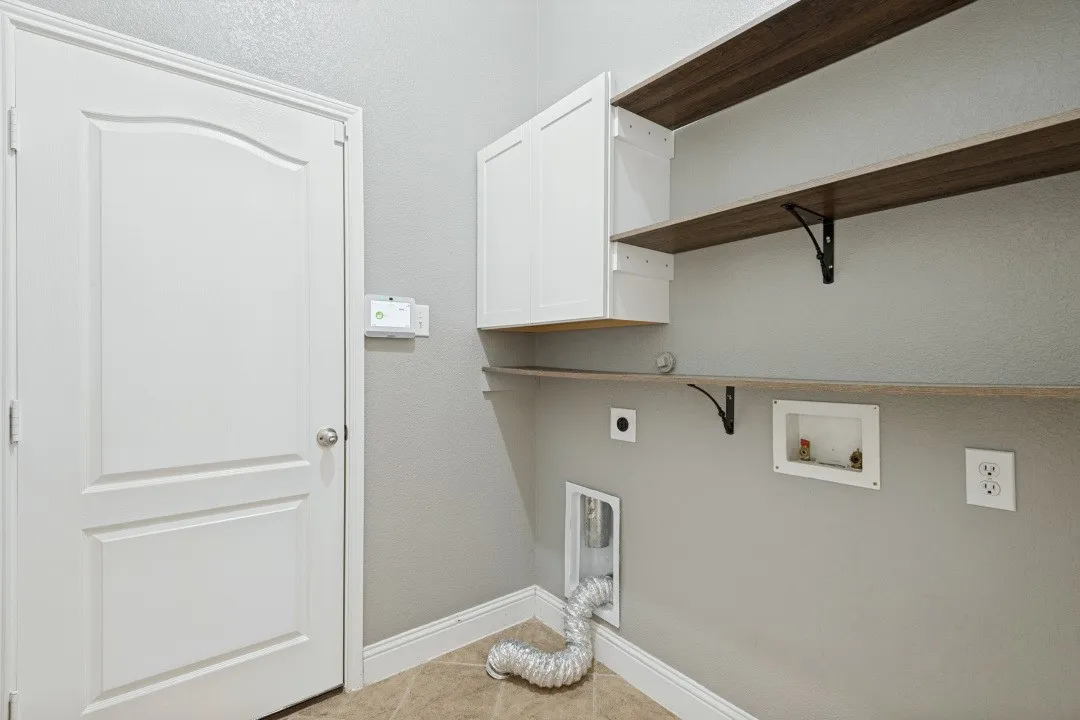 White cabinetry and wood-finish shelving provide organized storage