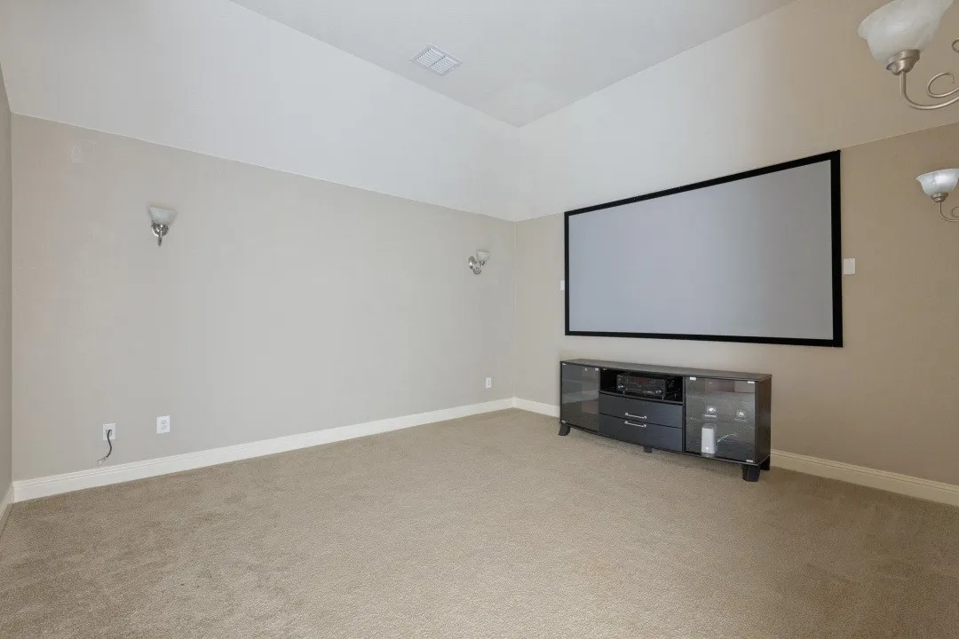 Huge home theater upstairs with screen, recessed lighting, and wall light fixtures