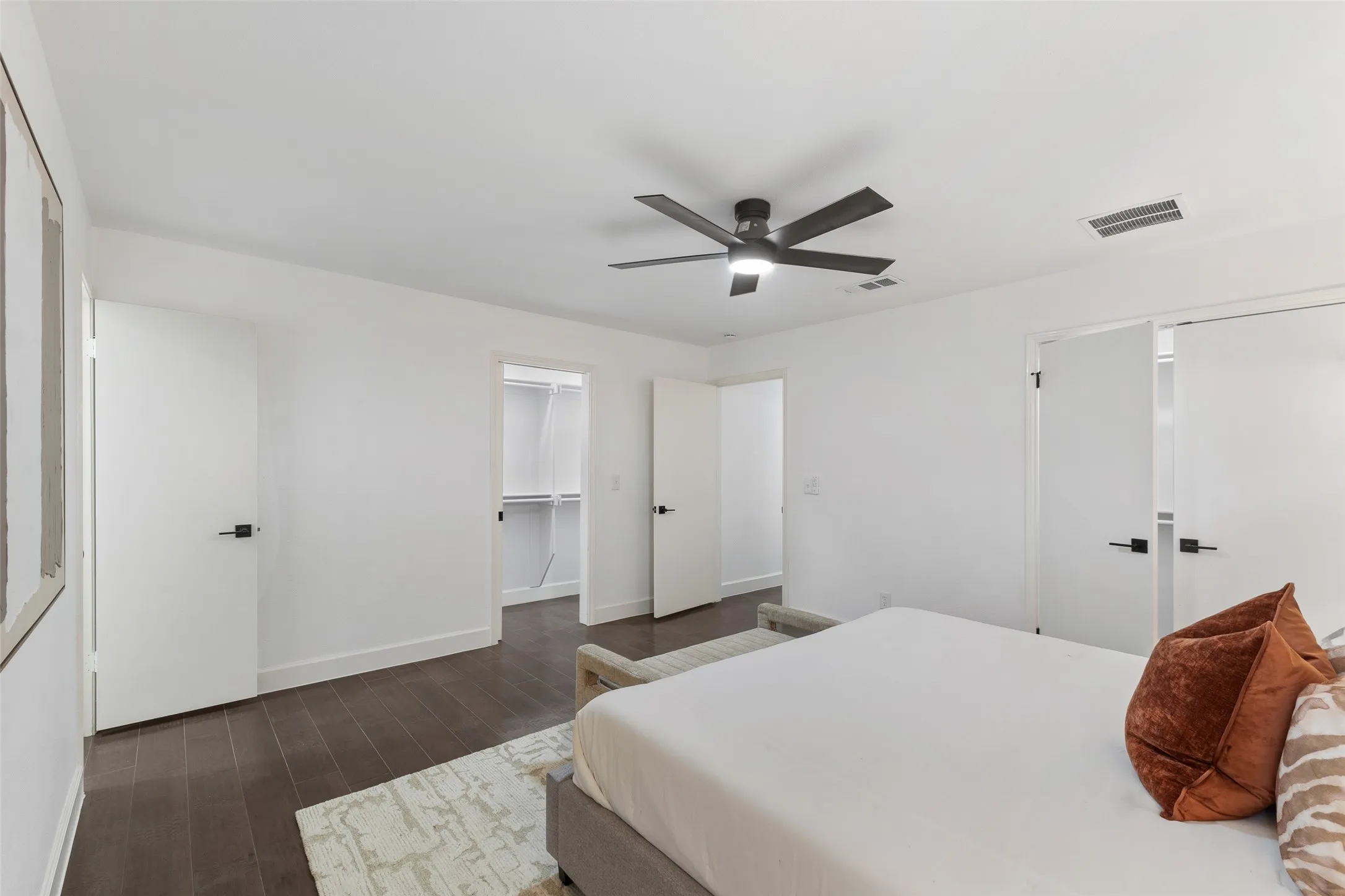Wood-finish flooring, white walls, and a contemporary ceiling fan with integrated lighting