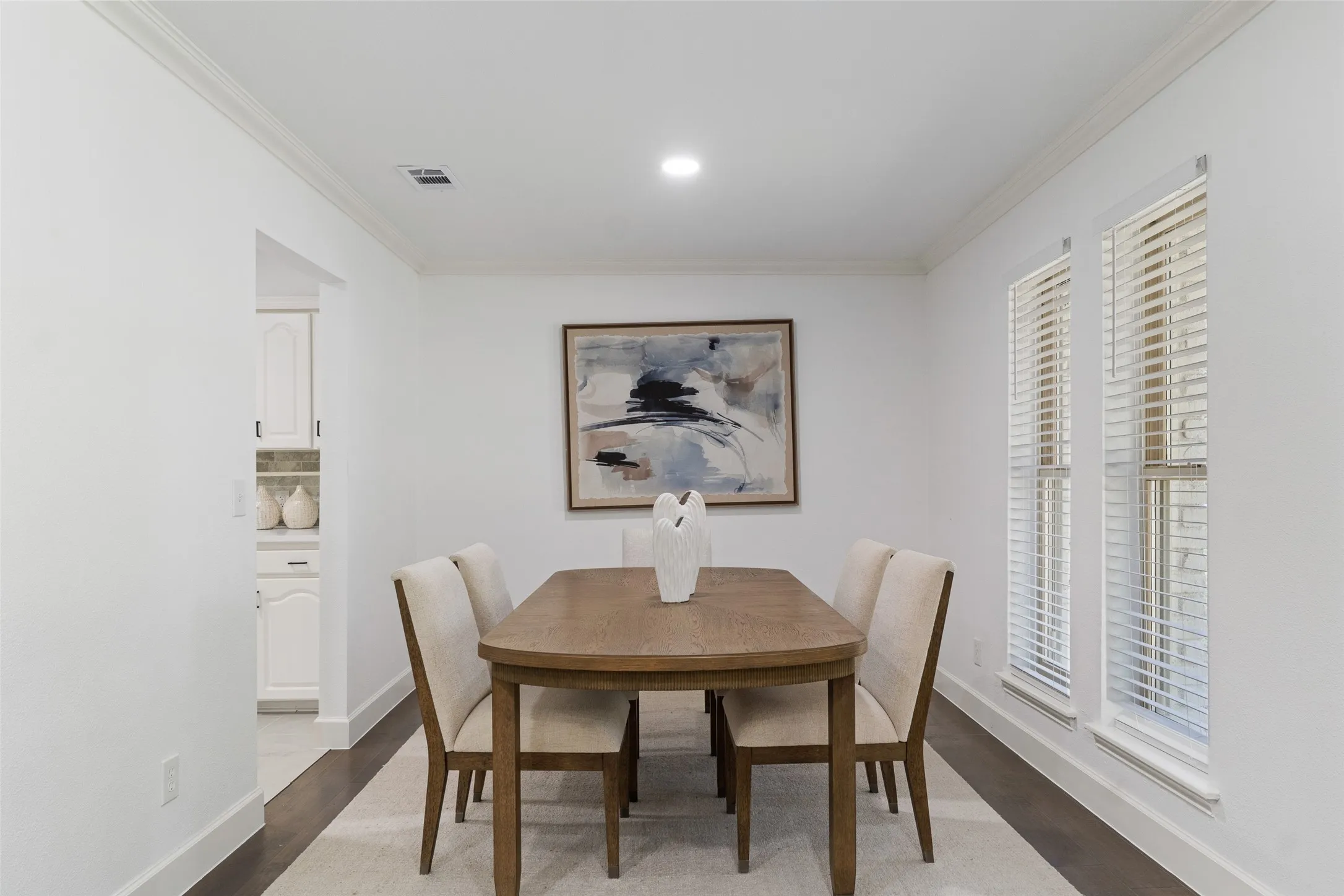 Recessed lighting, crown molding, and wood-finish flooring