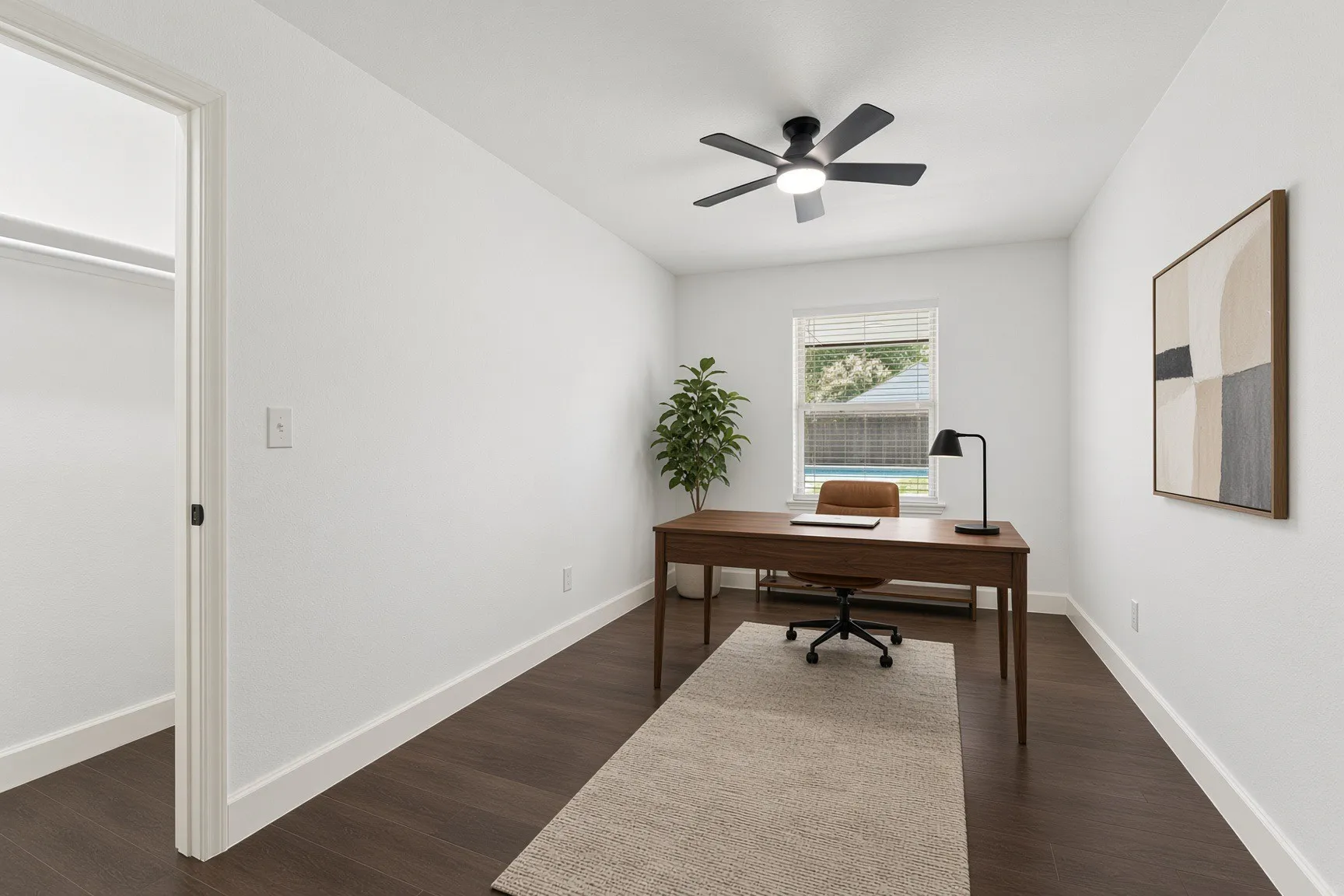 Room with wood-finish flooring, a ceiling fan with integrated lighting, a window featuring blinds, and a built-in closet