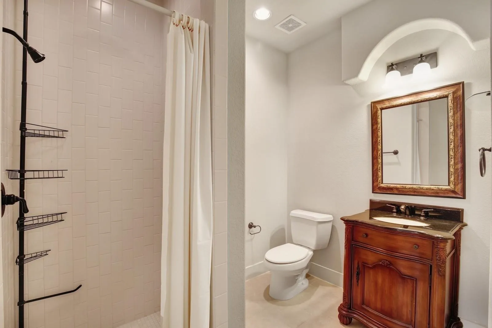 White subway tile shower surround with black-finish fixtures