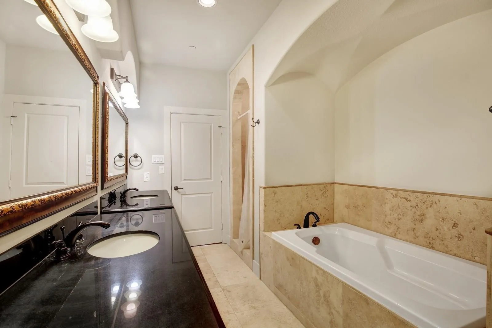 Dual vanity with dark stone-finish countertop