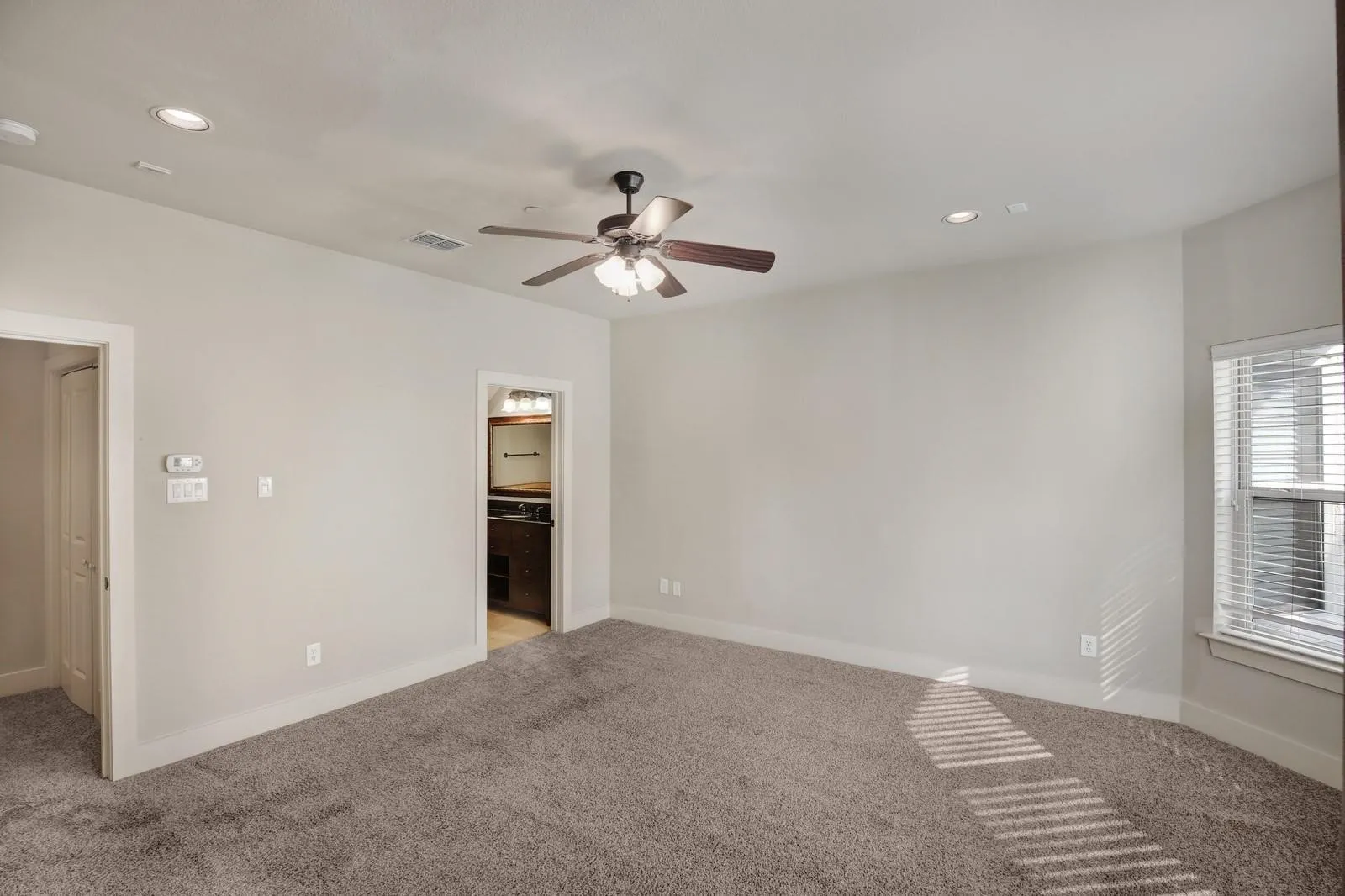 Recessed lighting, ceiling fan, carpeted flooring, window with blinds, and white trim