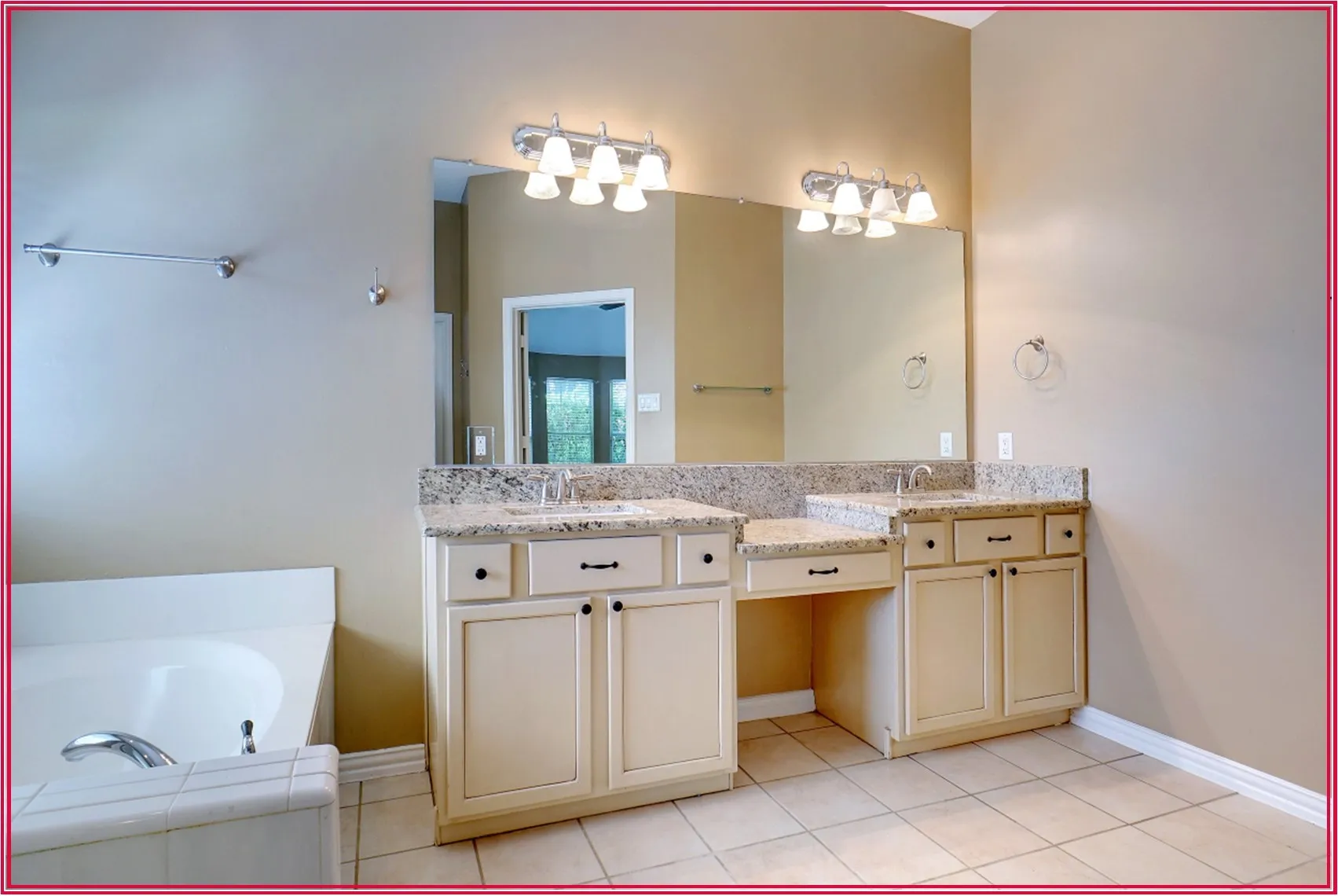 Dual vanity with granite countertops, integrated sinks, chrome fixtures, and white cabinetry