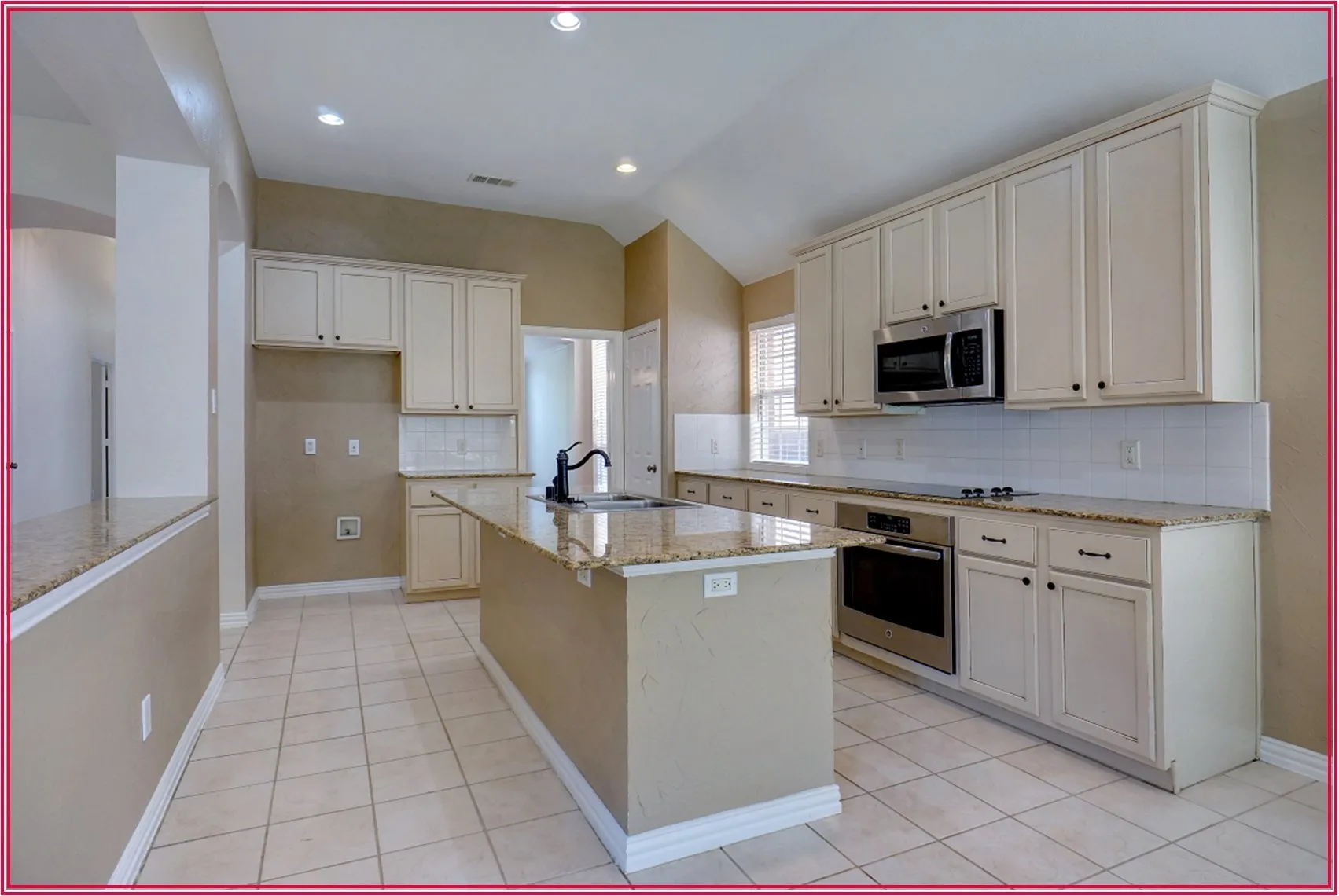 Kitchen featuring light-toned cabinetry, granite countertops, stainless steel appliances, a tiled backsplash, and recessed lighting