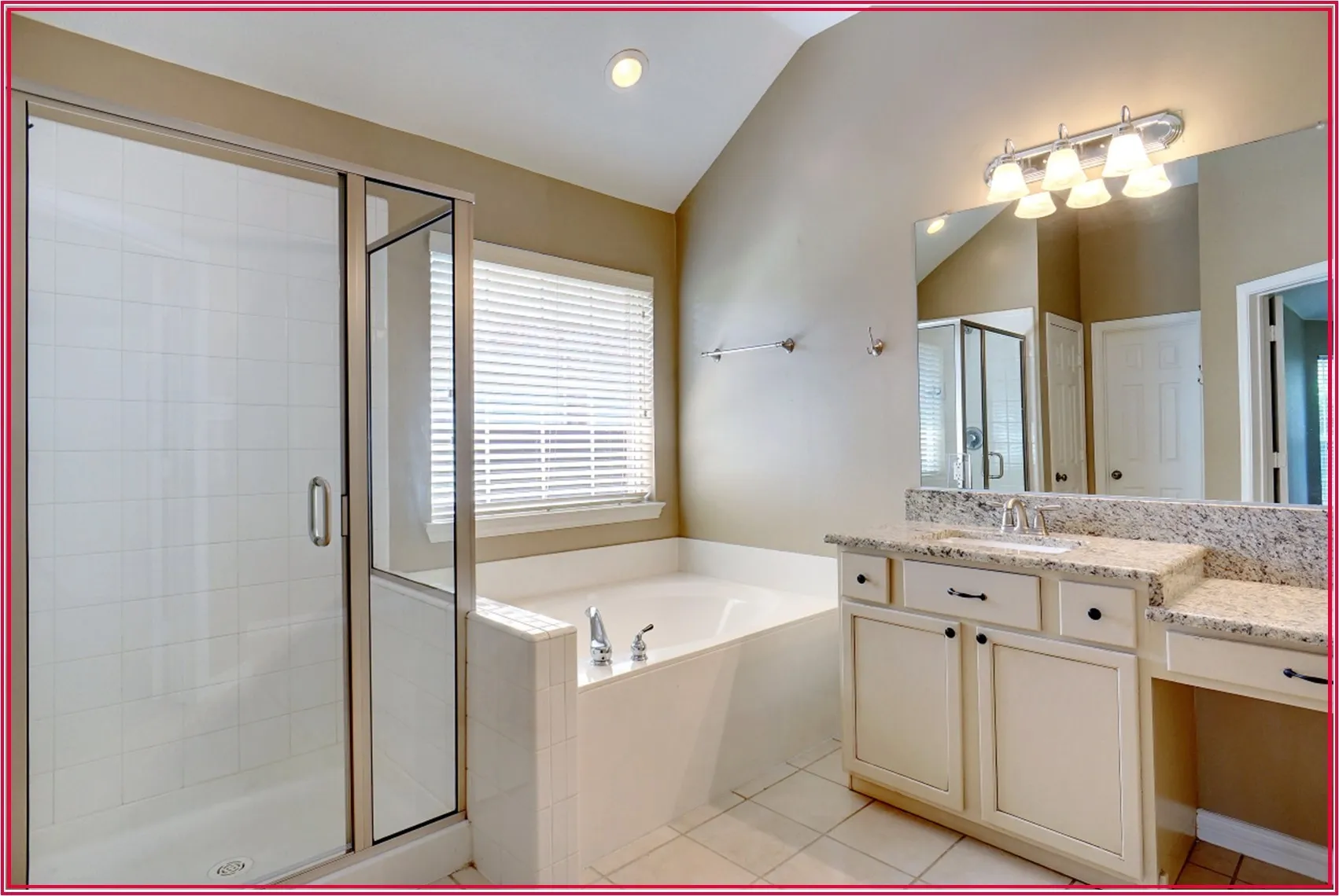 Spacious bathroom featuring a glass-enclosed shower, built-in soaking tub, vanity with granite-style countertop, and recessed lighting