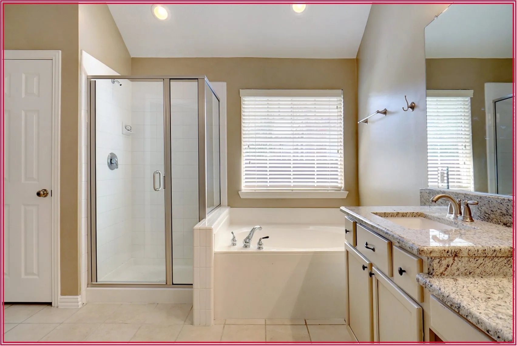Shower enclosure with a clear glass door, built-in bathtub, vanity with a light-toned countertop, and recessed lighting