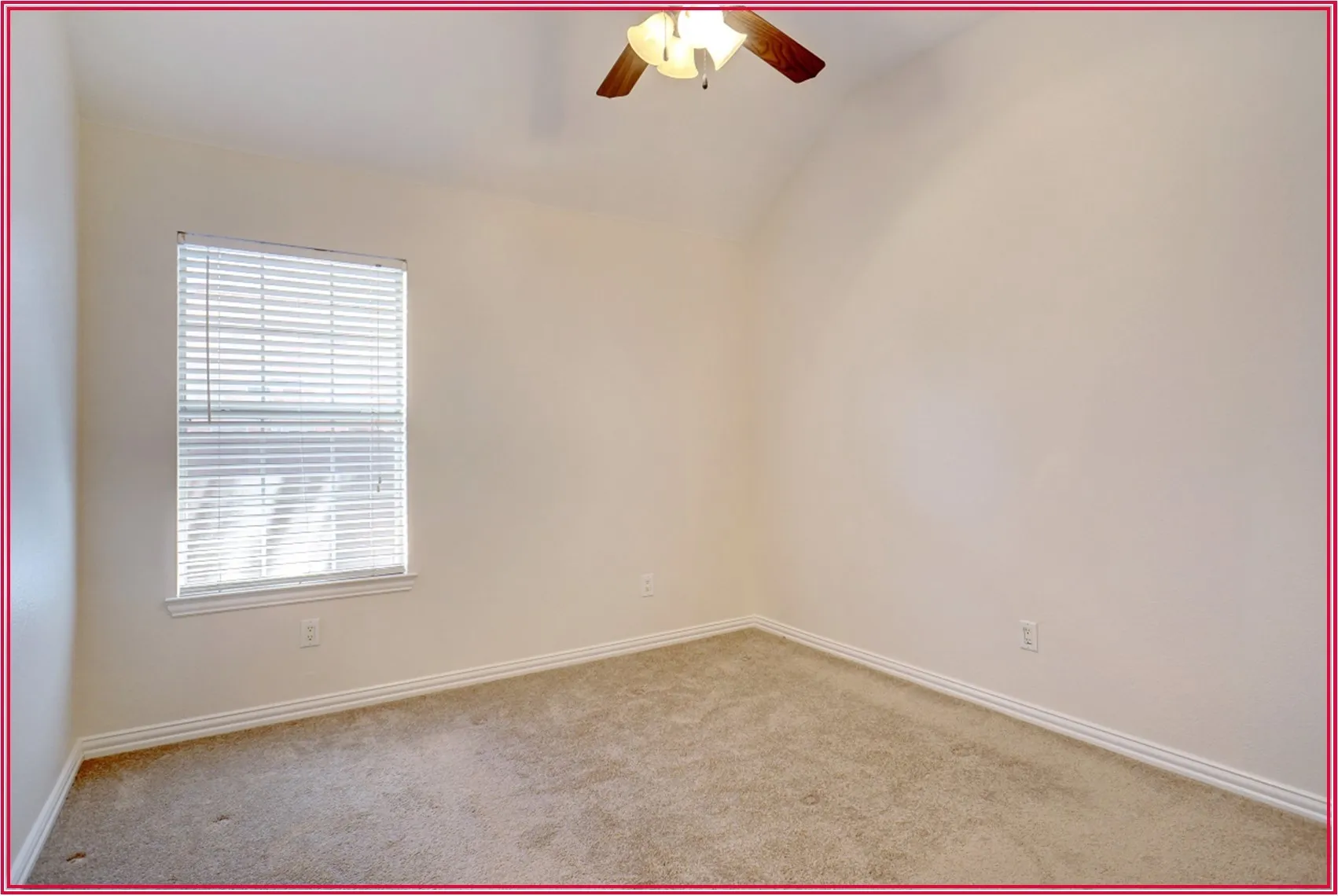 Vaulted ceiling with a ceiling fan, carpet flooring, and a window with blinds