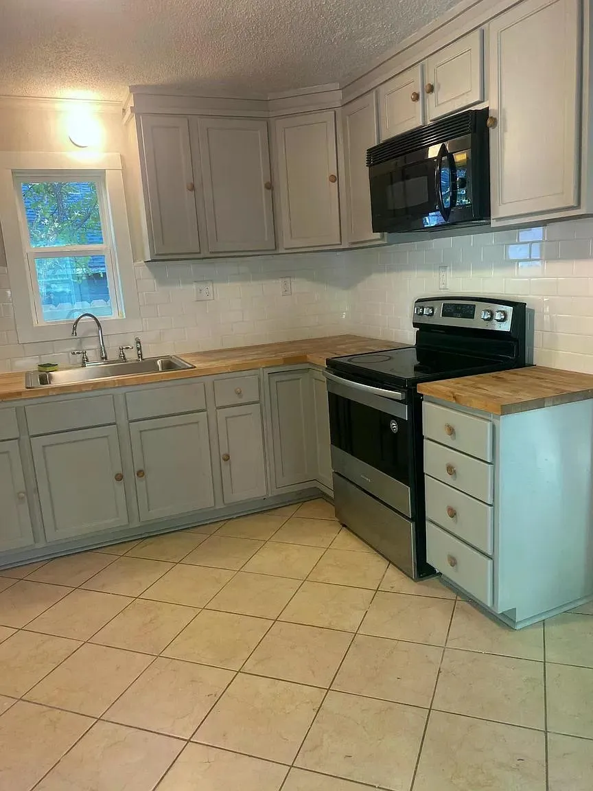 Light-toned cabinetry with wood-finish countertops