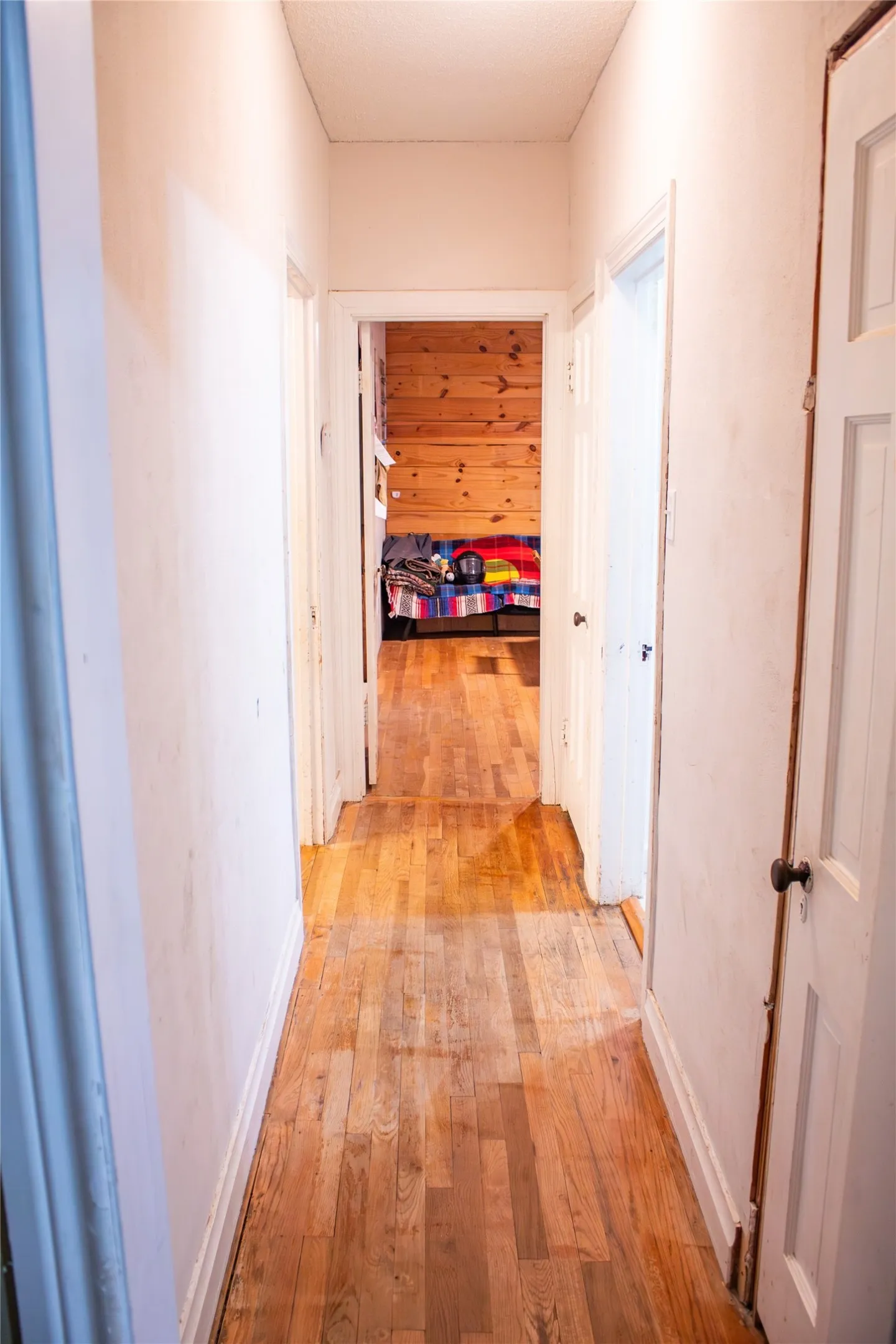Wood-finish flooring extending through a central corridor