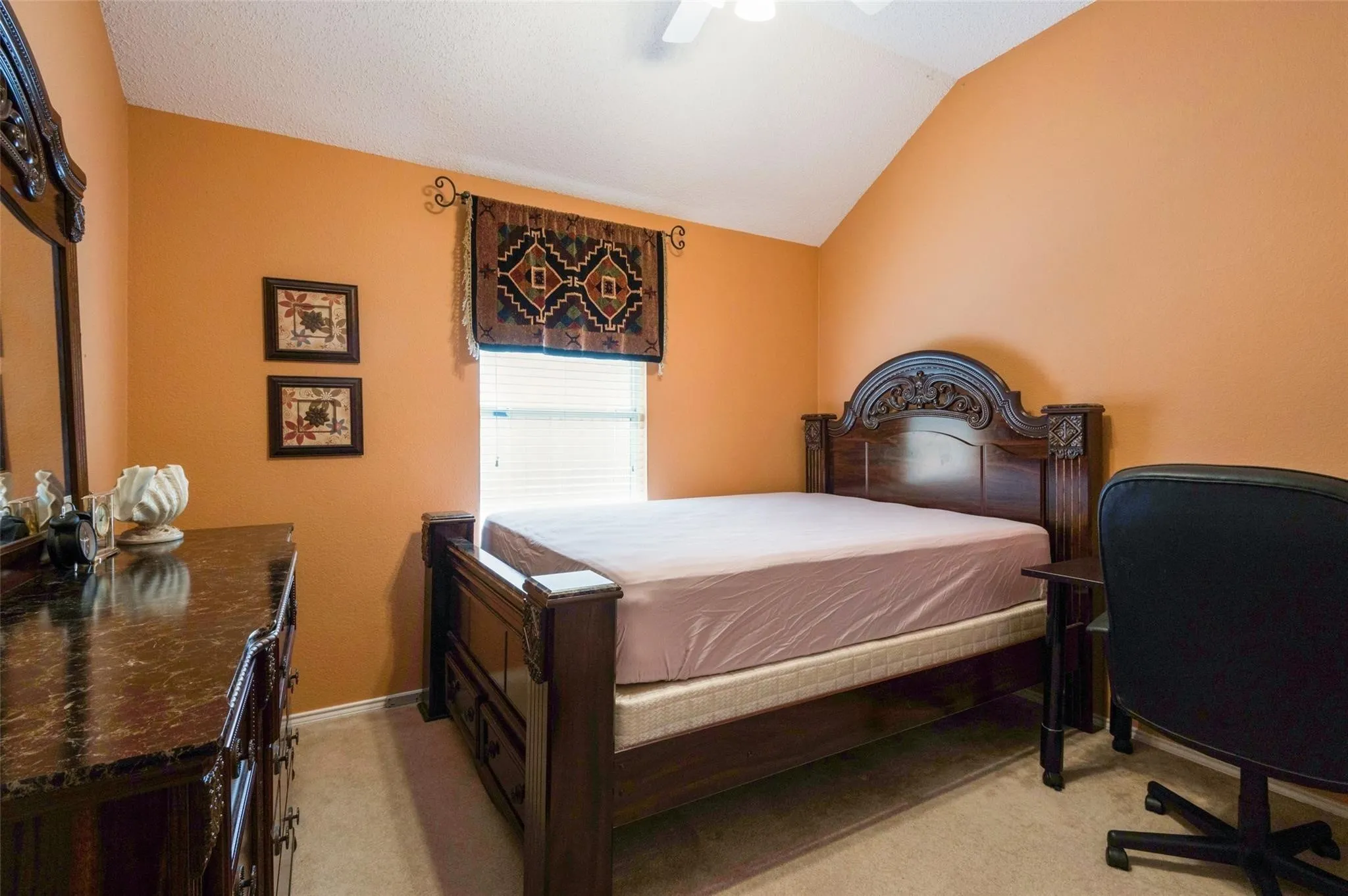 Vaulted ceiling with ceiling fan, wall-to-wall carpeting, and a window with blinds