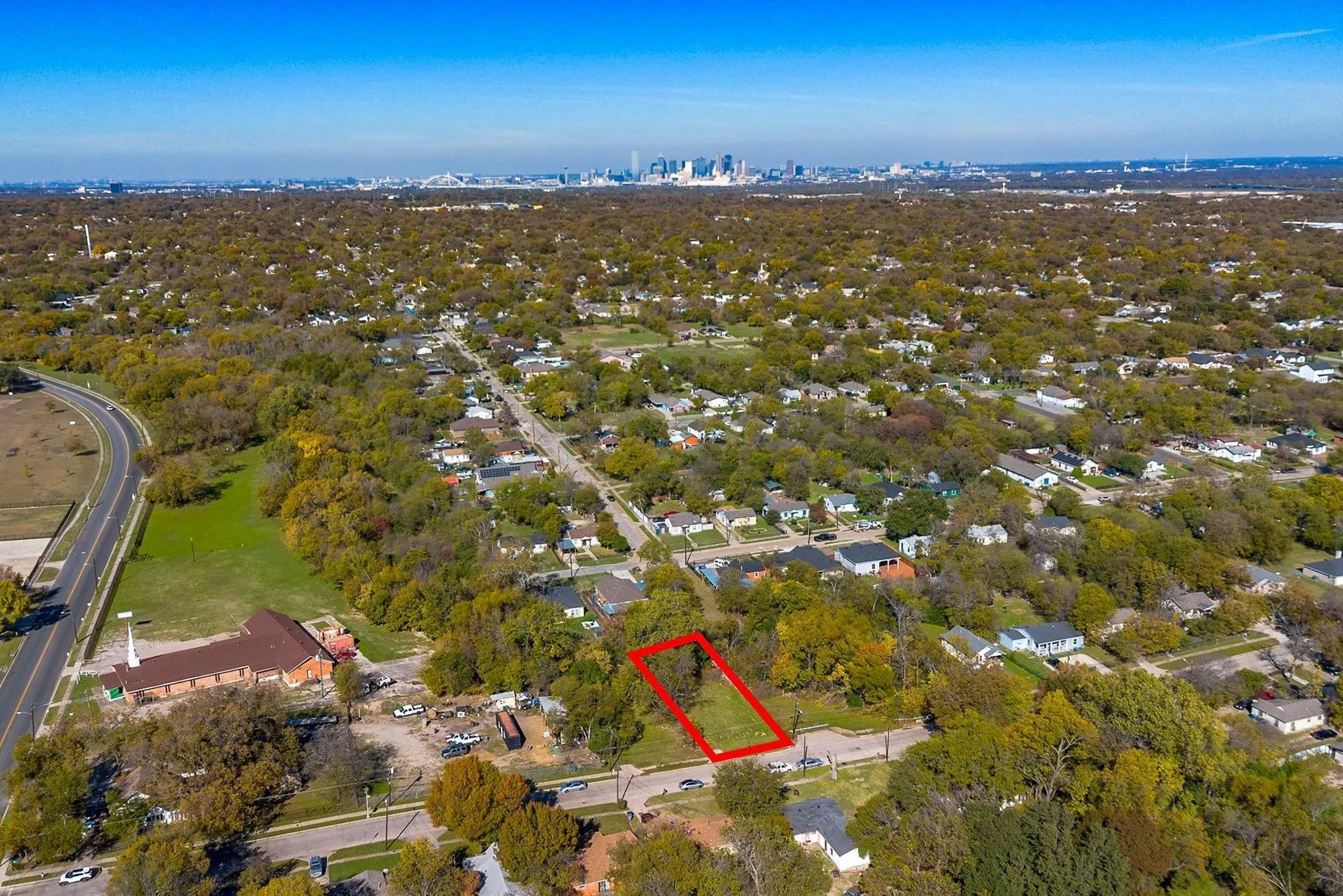 Expansive land parcel outlined in red, with a clear skyline visible in the distance