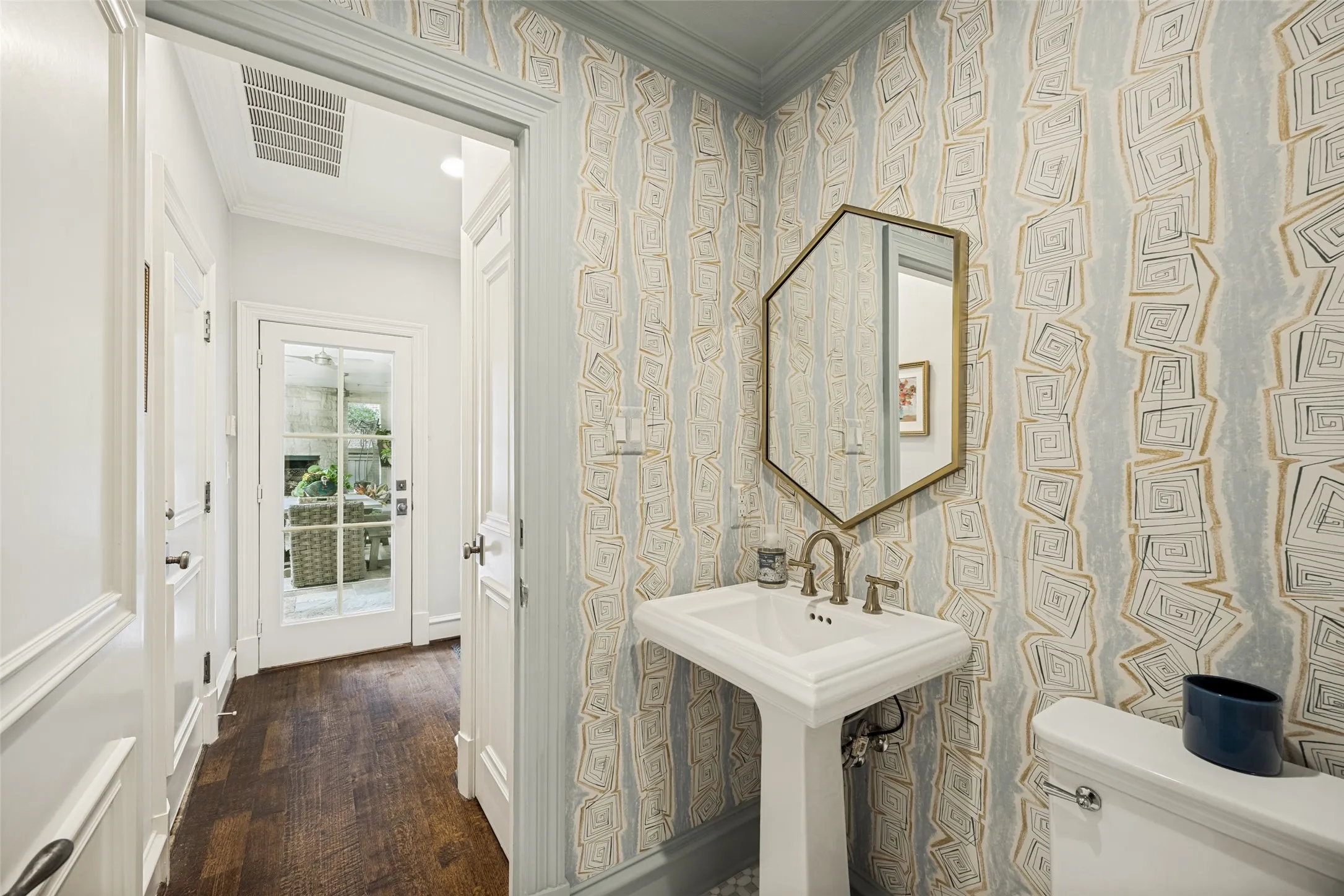 Downstairs half bathroom located close to the pool