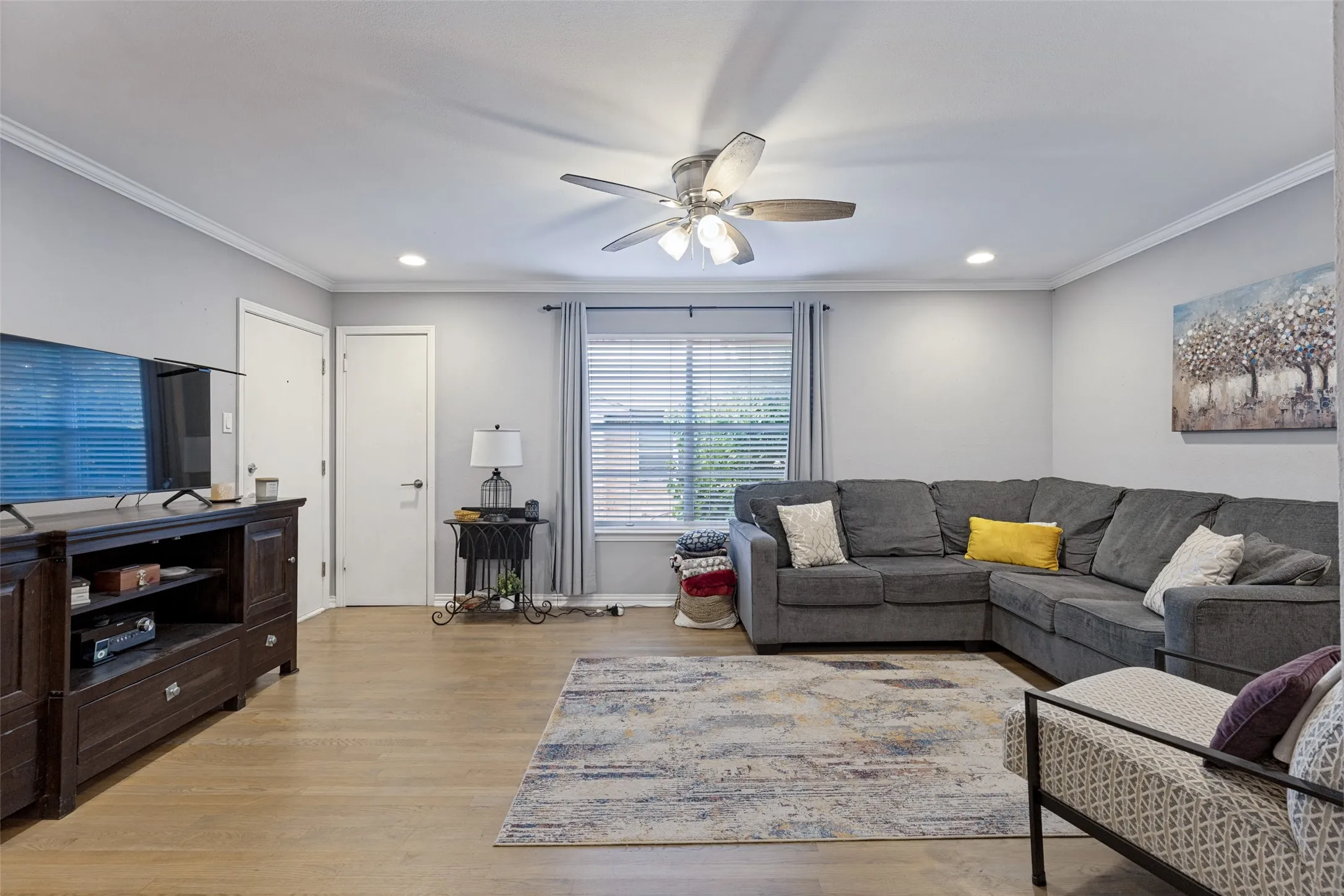 Light wood-finish flooring, recessed lighting, and a ceiling fan with light fixture
