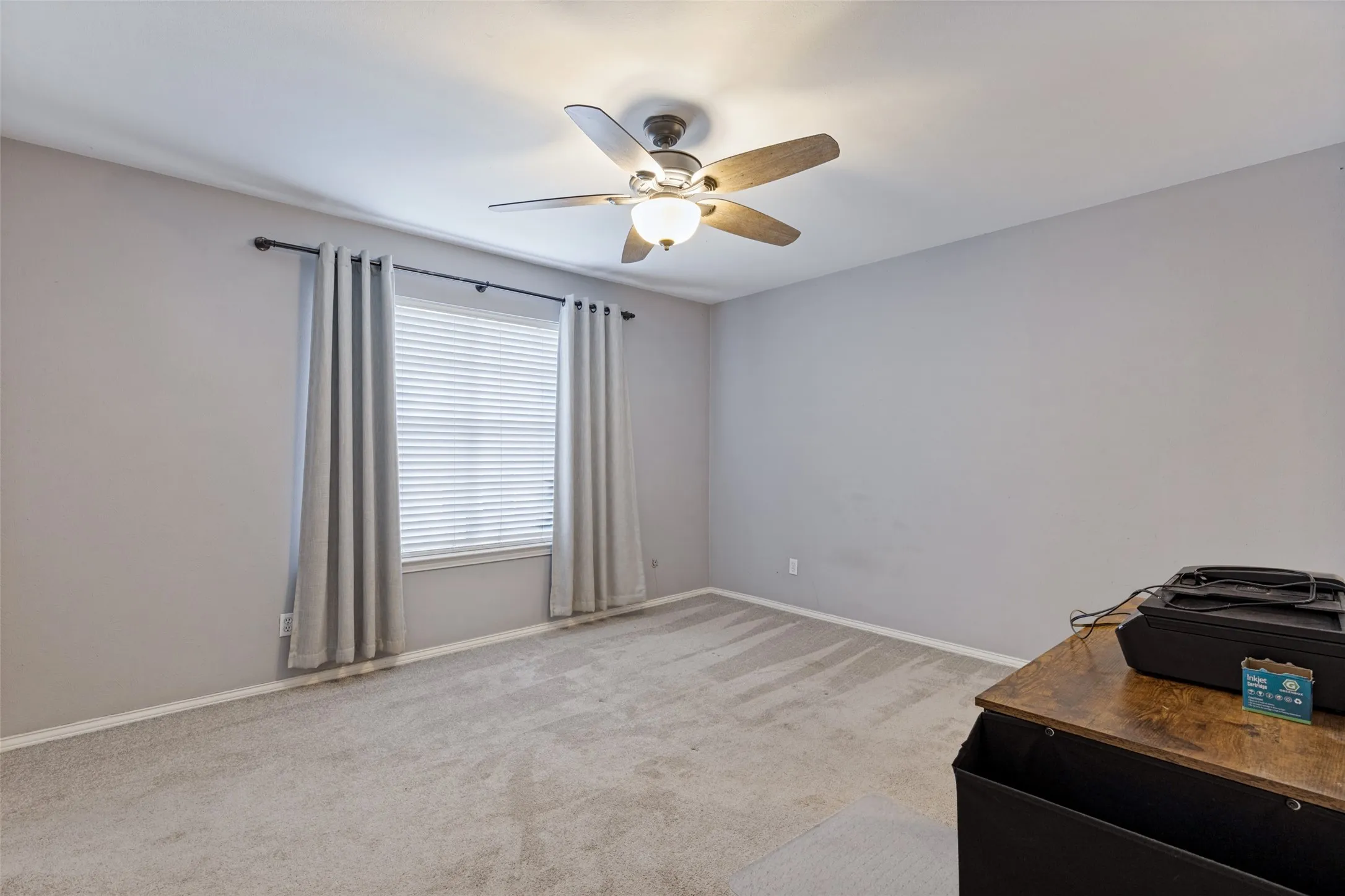 Carpeted flooring, window with blinds, ceiling fan with integrated lighting, and neutral wall paint