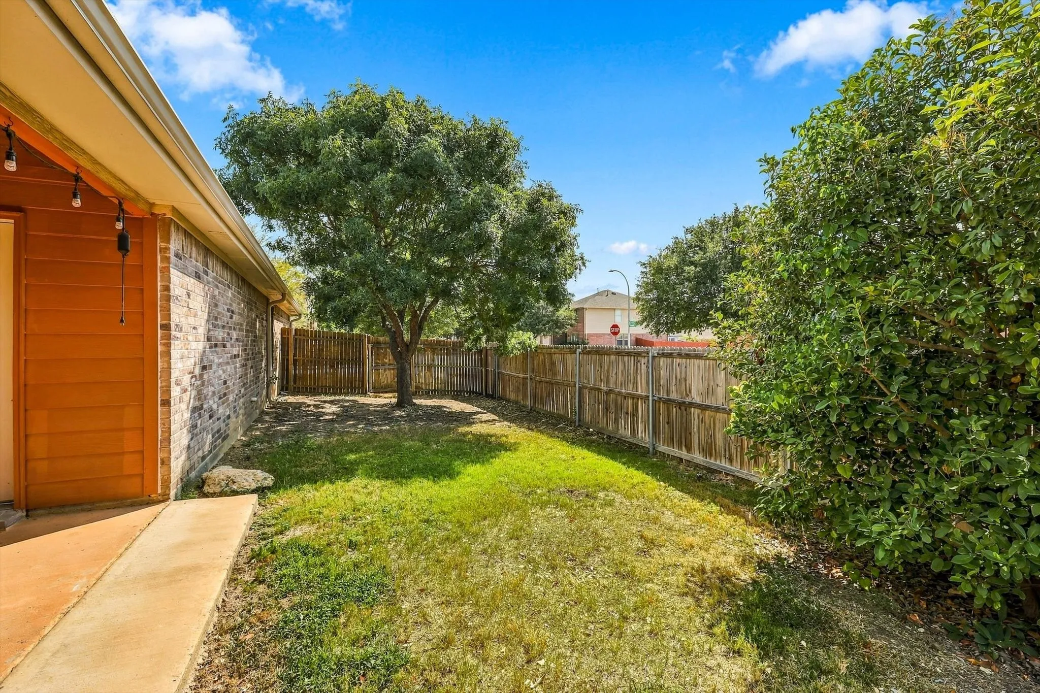 Grassy side yard great for kids or pets.