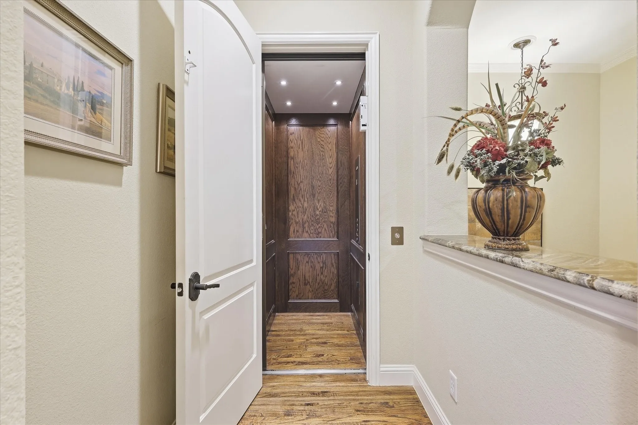 Elevator with wood-paneled interior and recessed lighting