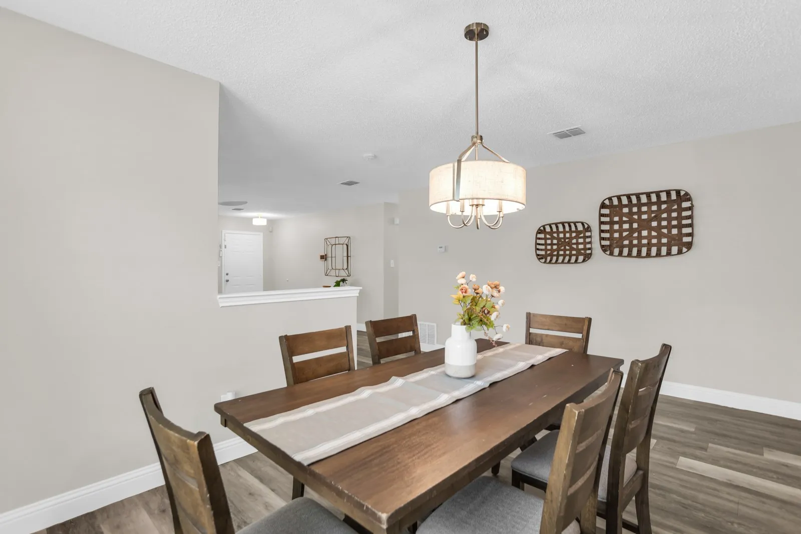 Recessed lighting, wood-finish flooring, and a contemporary drum pendant light