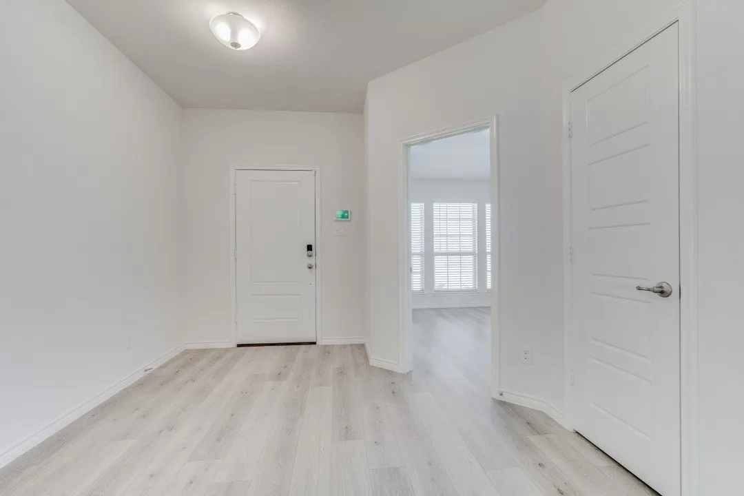 back of the front door and looking into the up front secondary bedroom