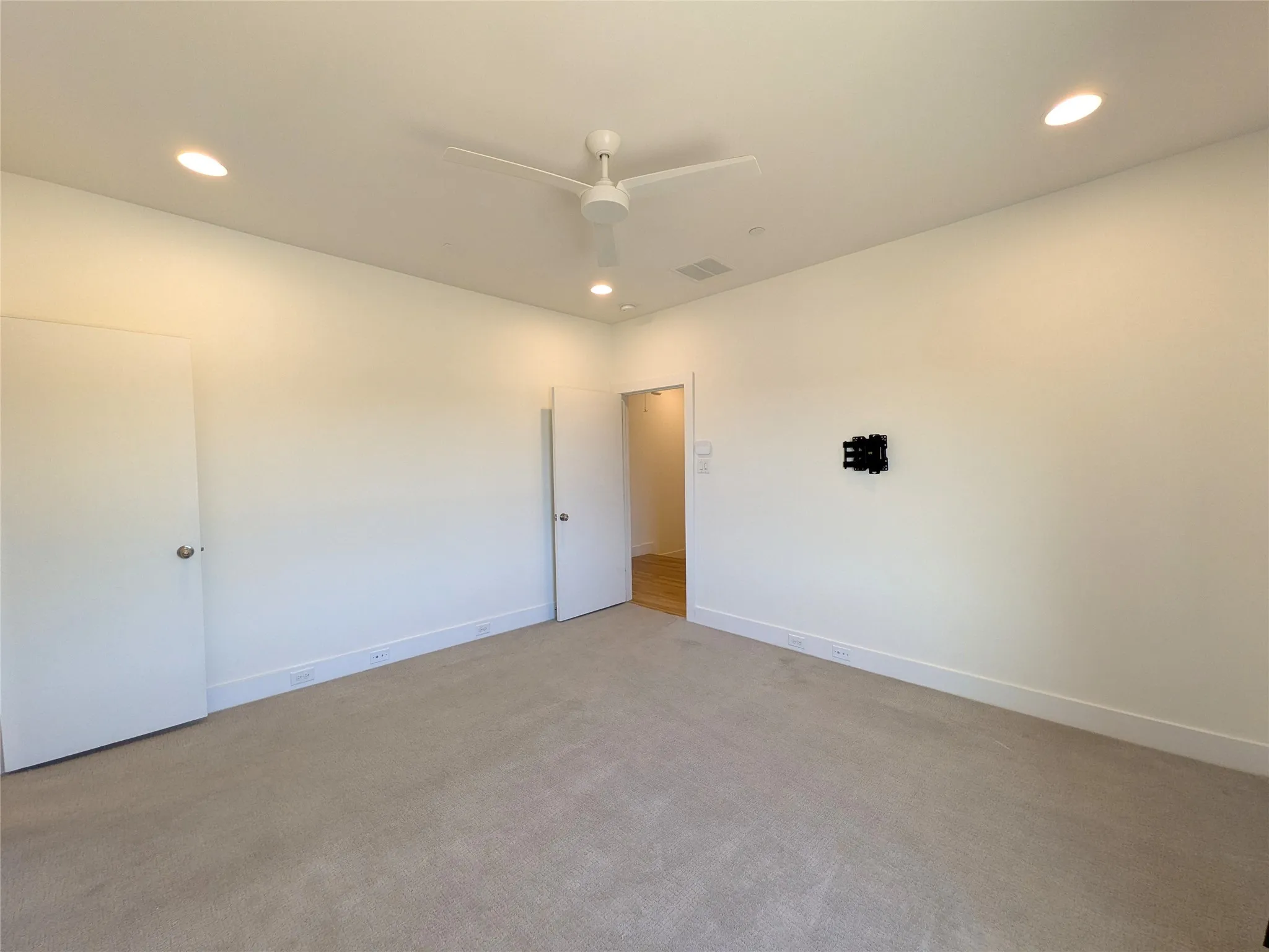 Recessed lighting, ceiling fan, and carpeted flooring