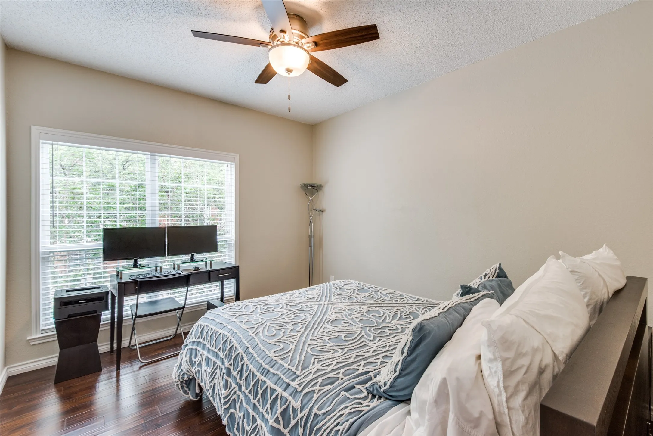 Wood-finish flooring with a ceiling fan light fixture