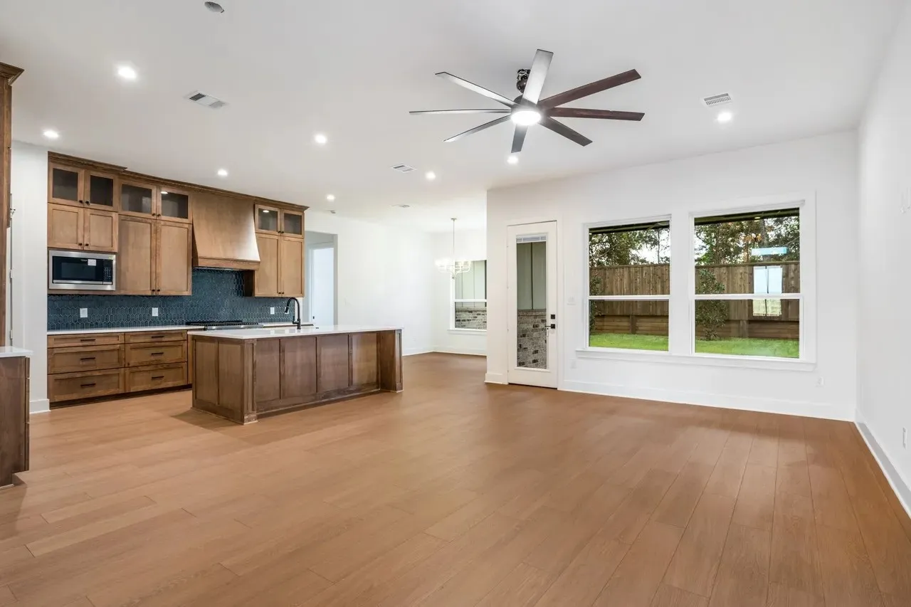 Wood-finish flooring, recessed lighting, and a modern ceiling fan