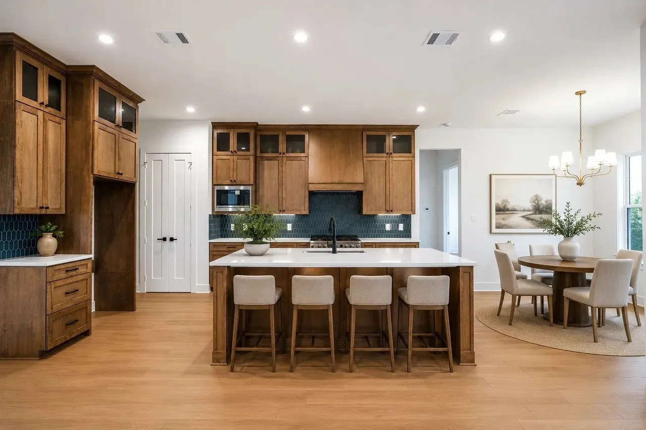 Wood-finish flooring, recessed lighting, and a kitchen island with a white countertop