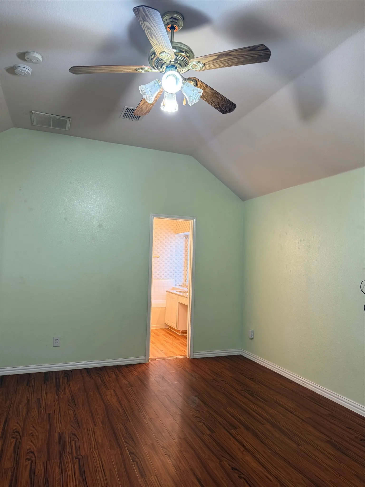 Vaulted ceiling featuring a ceiling fan with integrated lighting