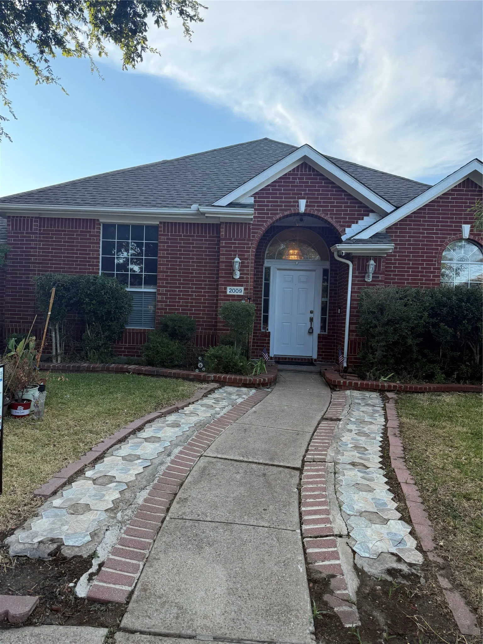Red brick exterior with an arched entry