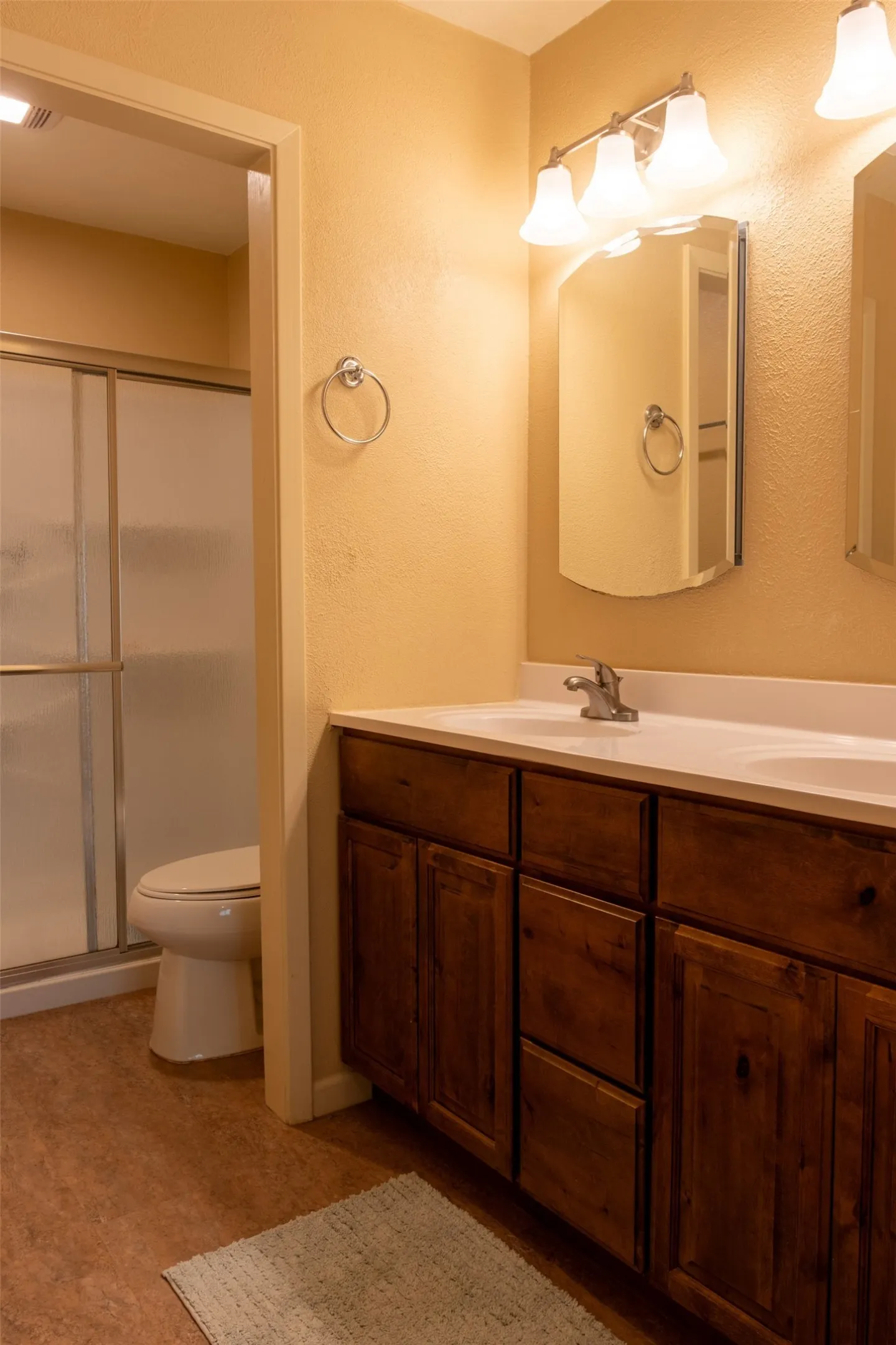Dual vanity with integrated white sinks and chrome fixtures
