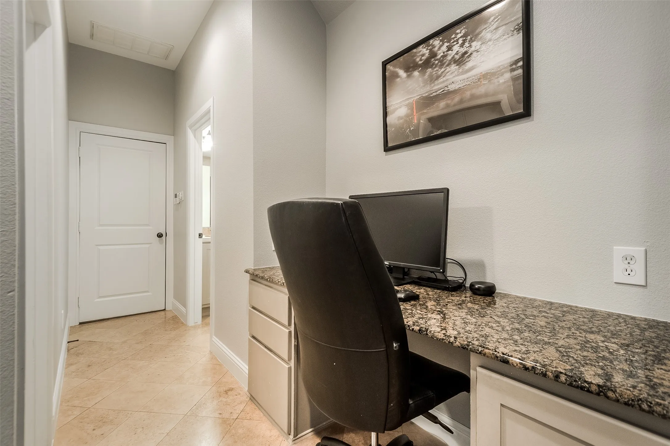 office space, door to garage straight ahead, bathroom to the right, bedroom to the left