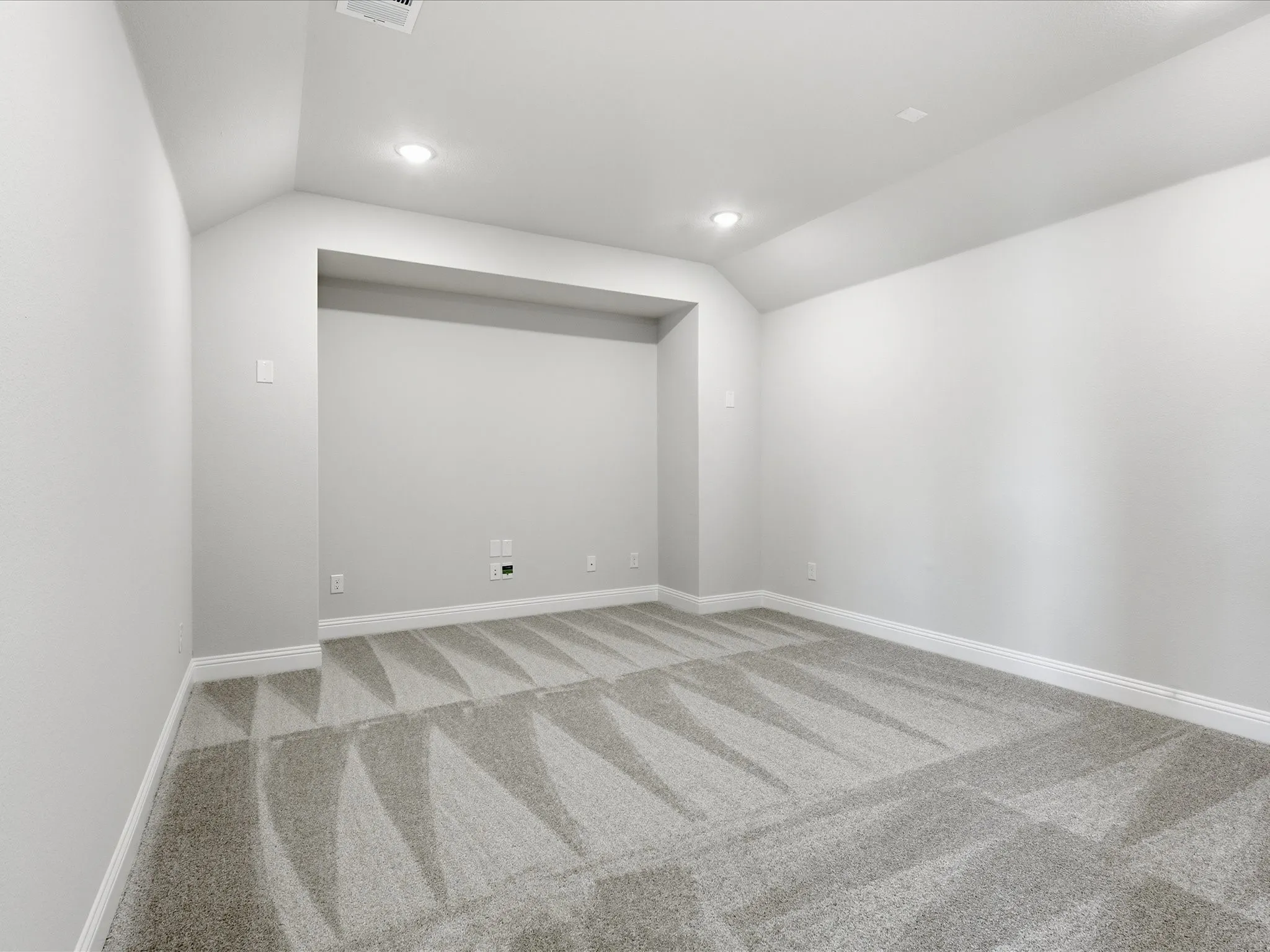 Unfurnished room featuring vaulted ceiling, light colored carpet, and recessed lighting