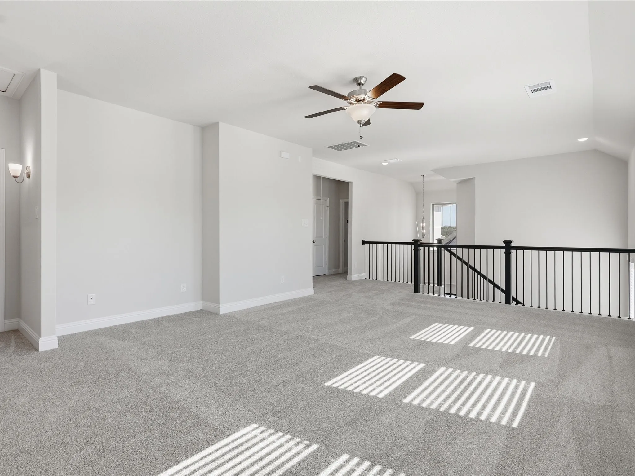 Spare room featuring light colored carpet, a chandelier, and recessed lighting
