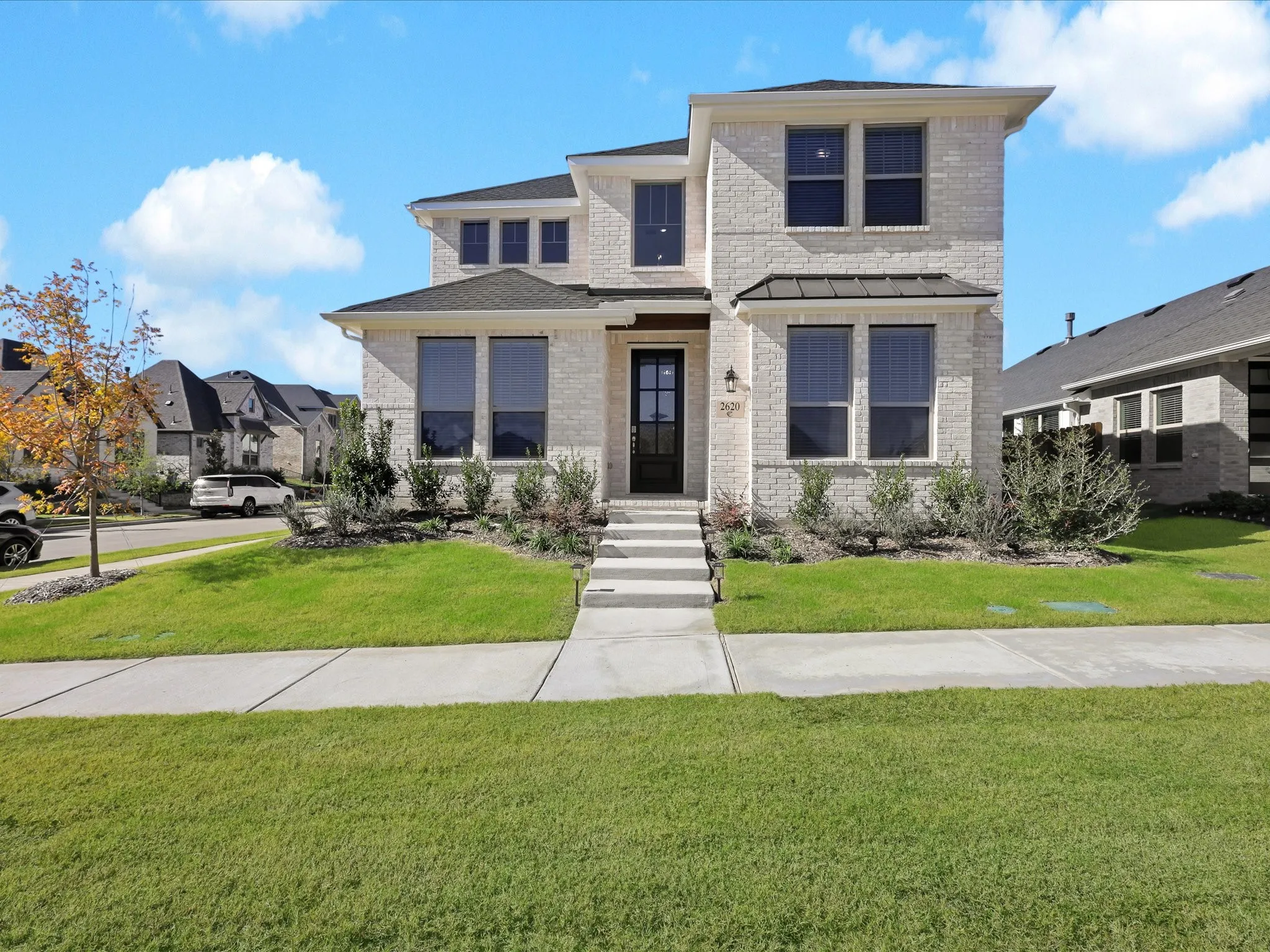 View of front of home with brick siding and a front yard