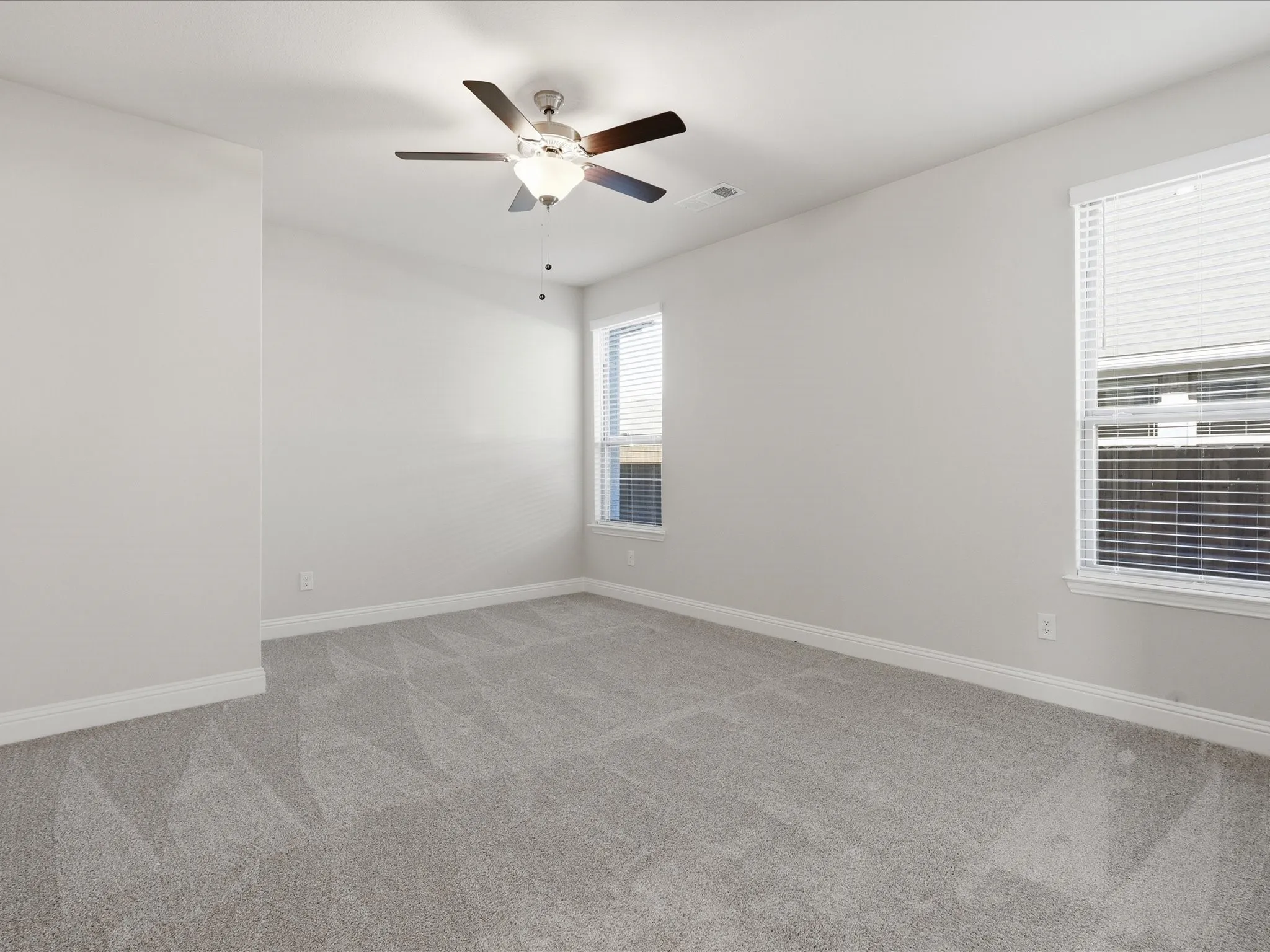 Spare room with light colored carpet and ceiling fan