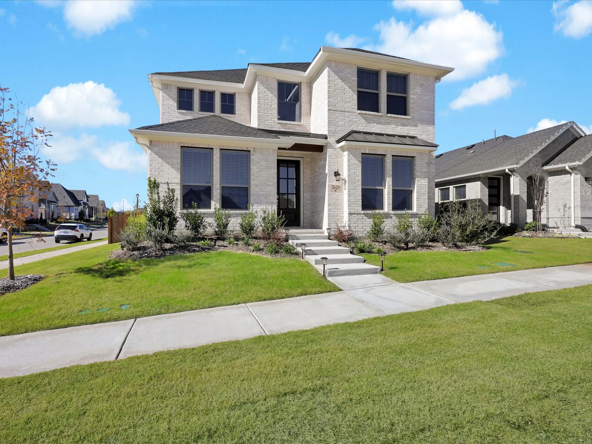 View of front of home featuring brick siding and a front lawn