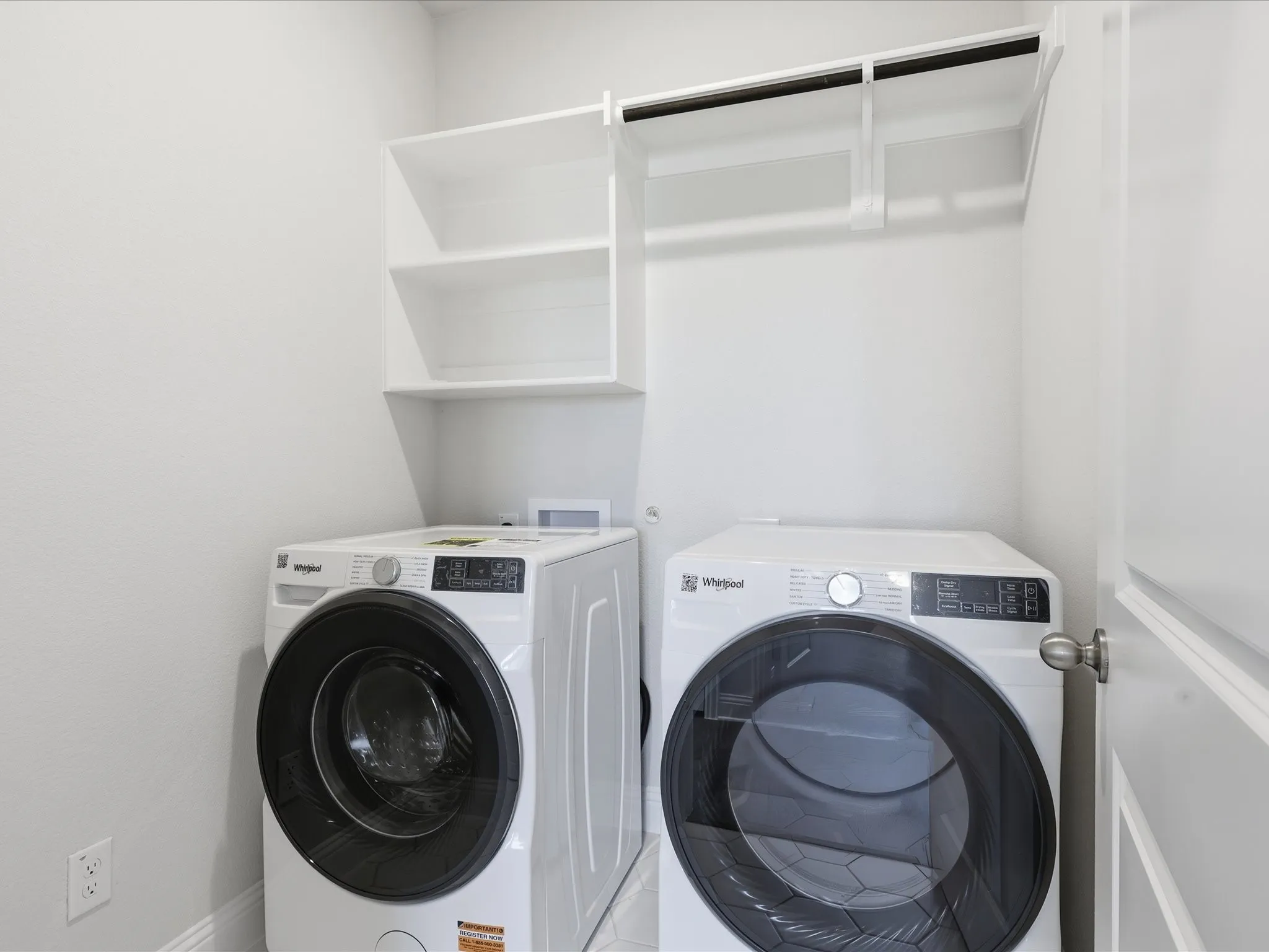 Laundry room featuring separate washer and dryer and baseboards