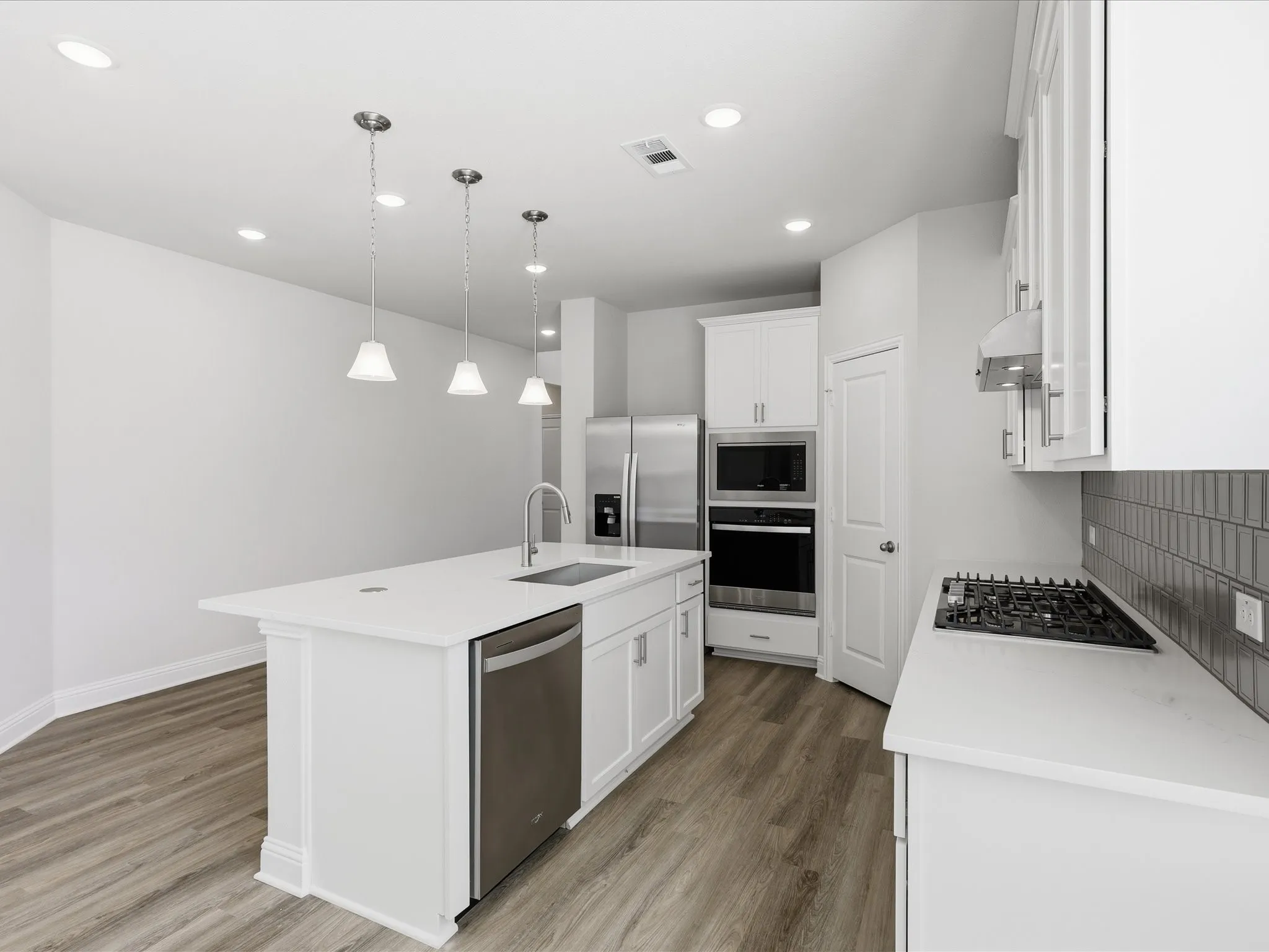 Kitchen featuring white cabinets, pendant lighting, dark wood-style flooring, and recessed lighting