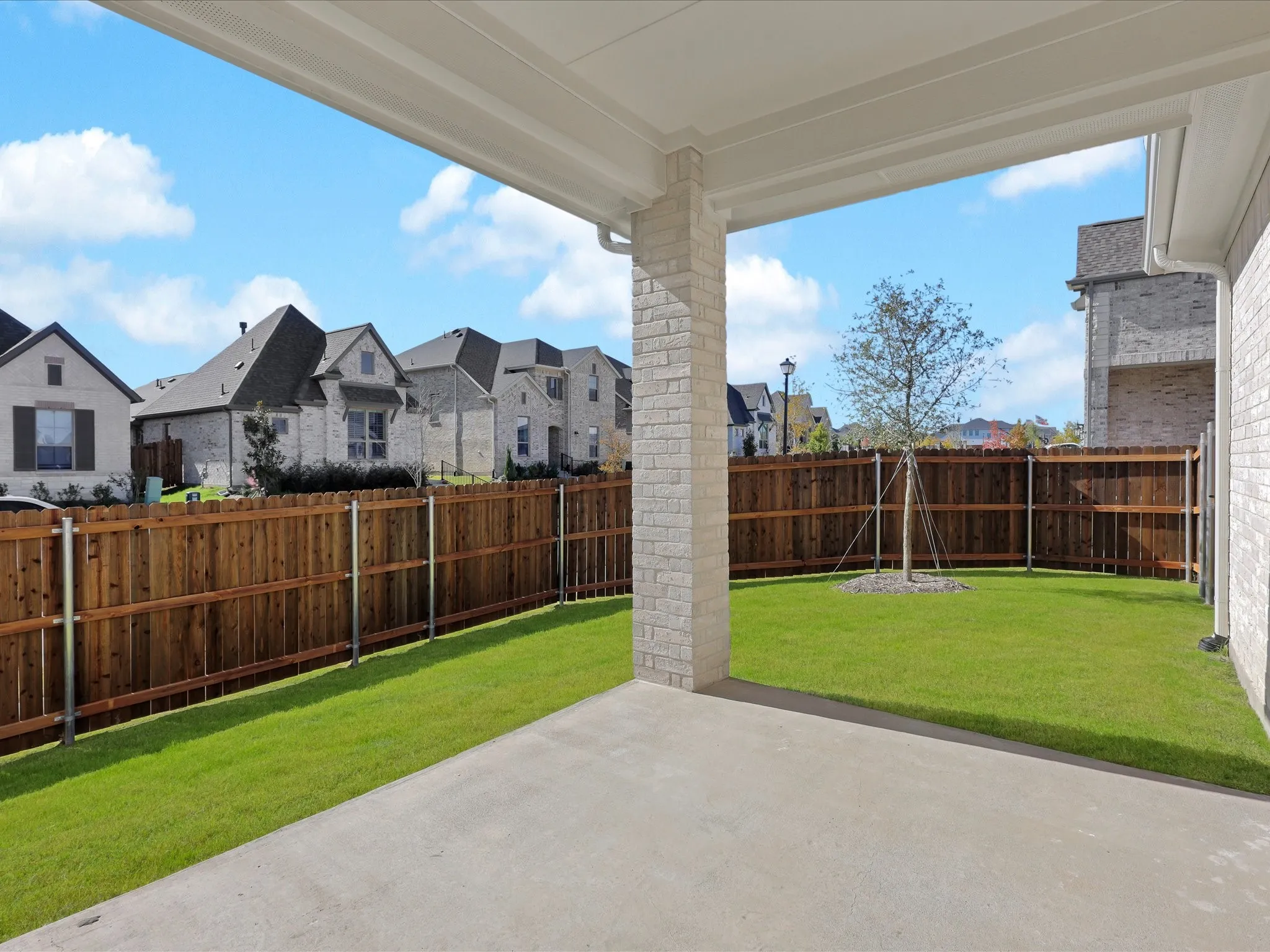 Fenced backyard with a patio and a residential view
