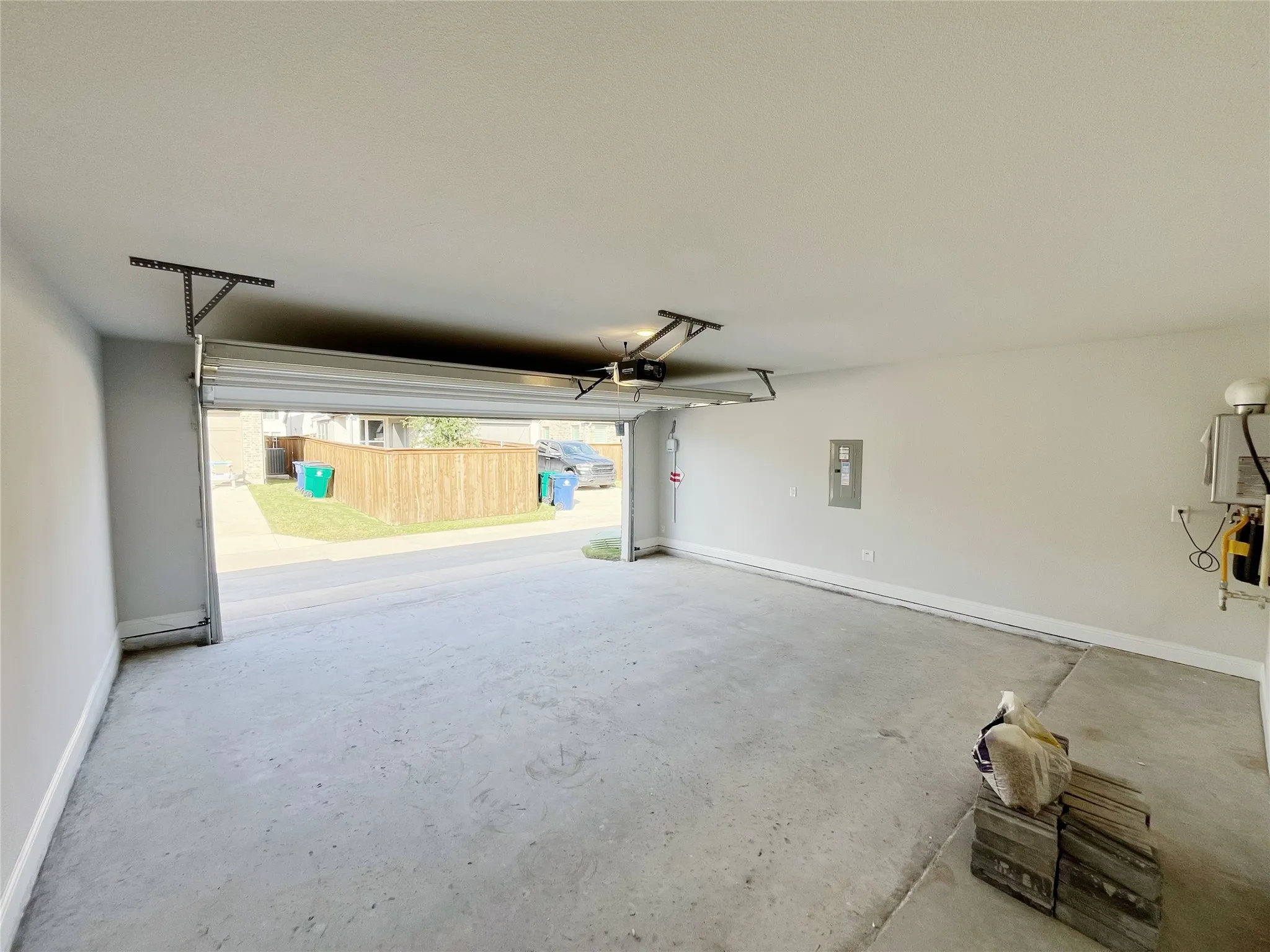 Attached garage space featuring a concrete floor and neutral-toned walls